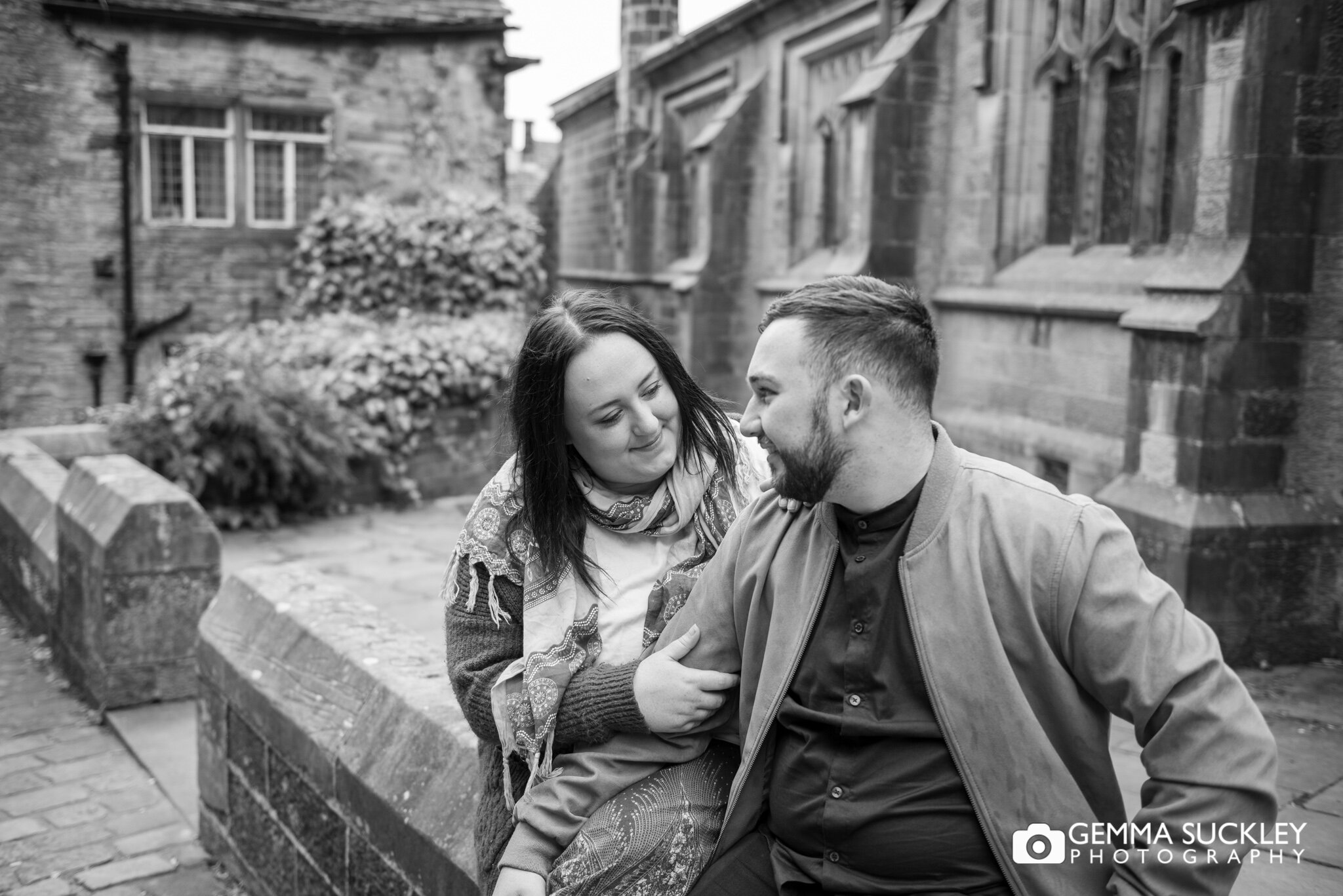 black and white photo of an engaged couple laughing in haworth