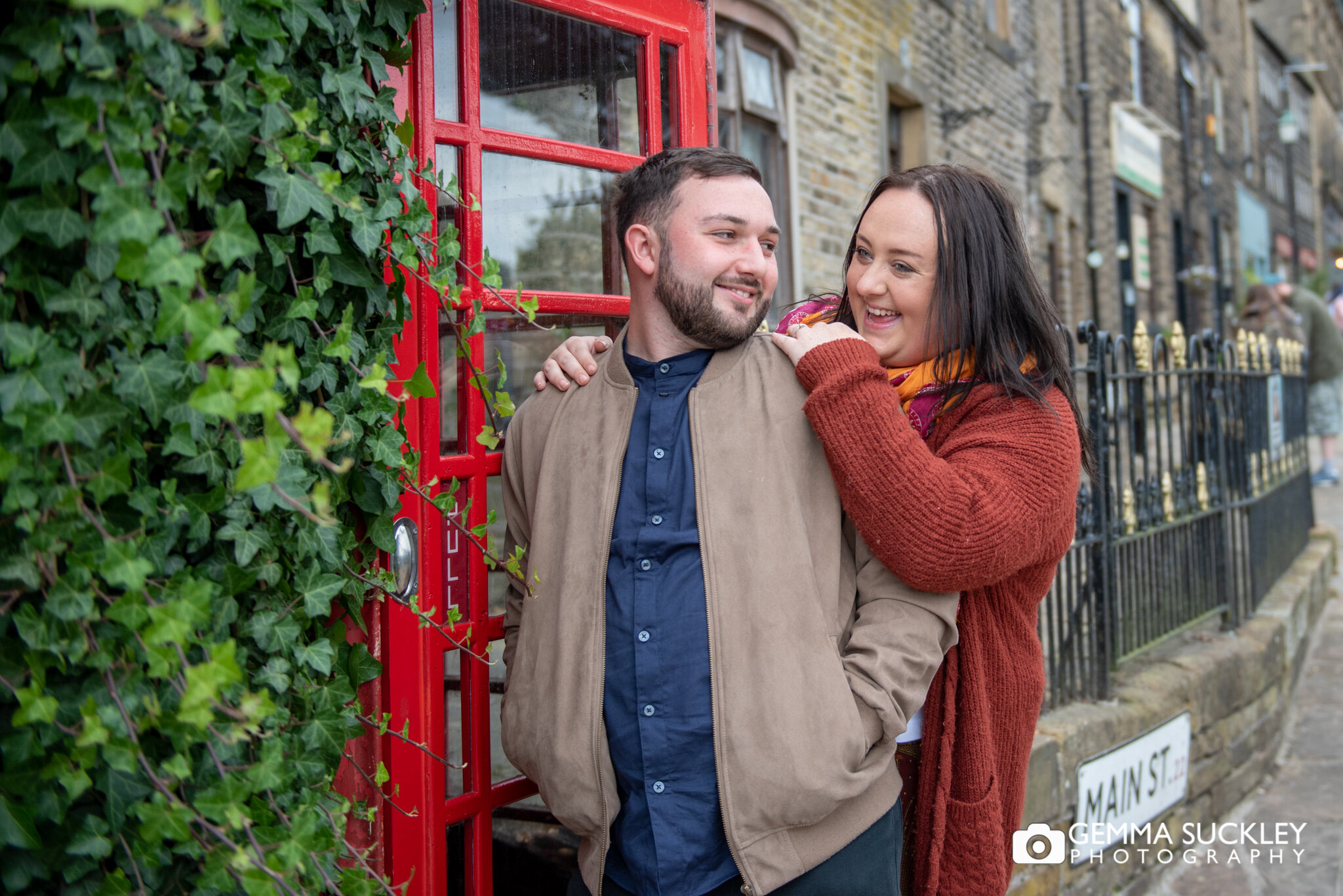 engaged couple by the phone box in haworth