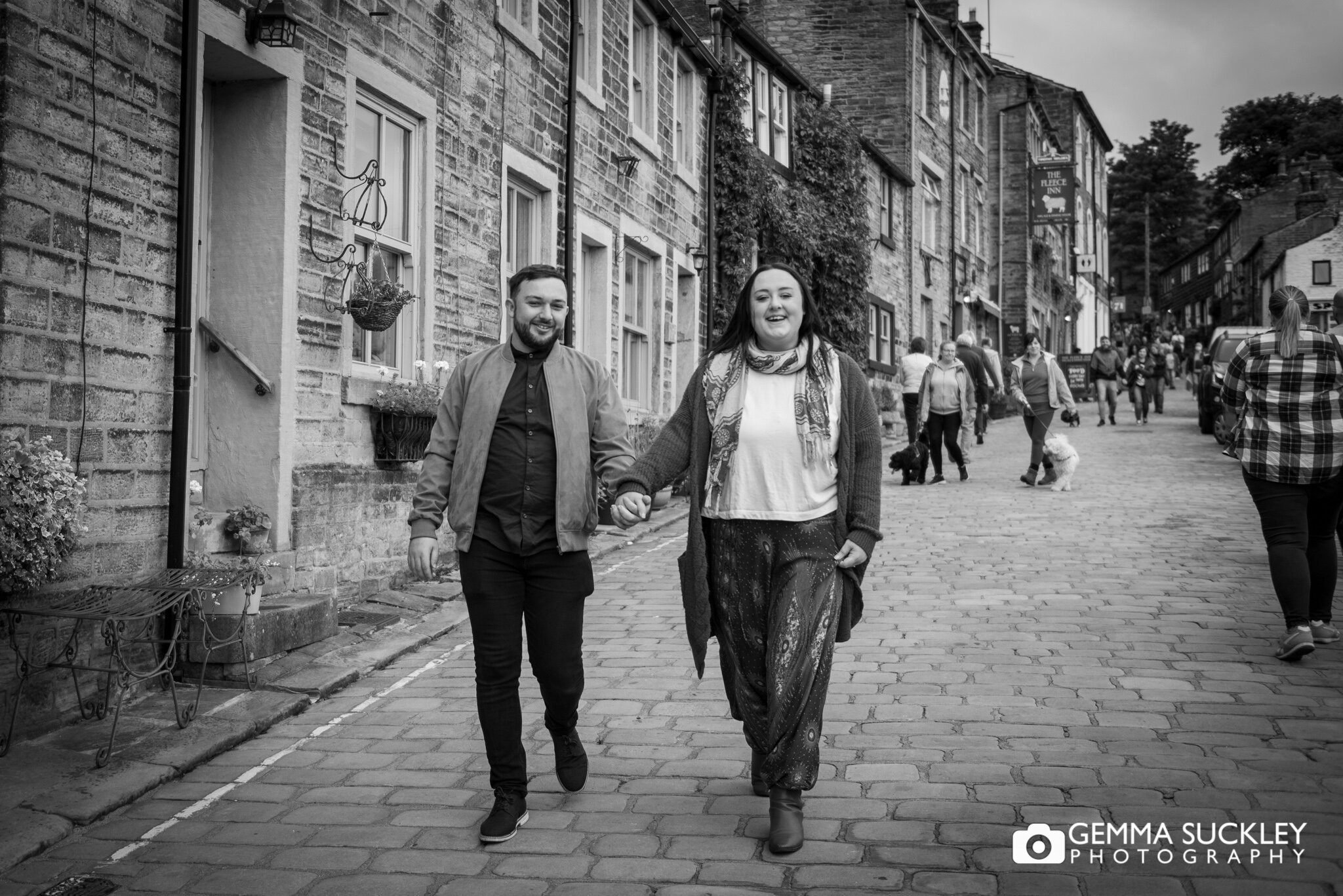 a couple walking down main street in haworth