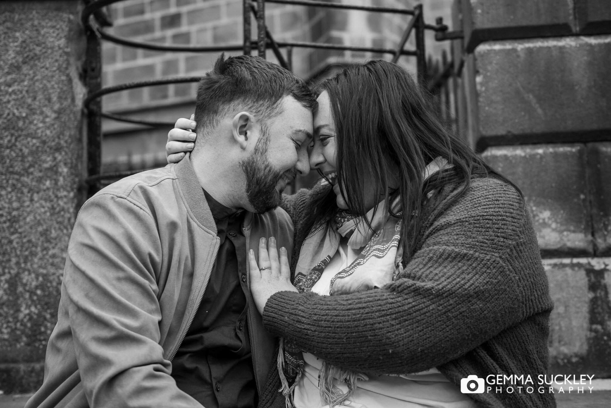 a black and white photo of a couple kissing during their photo shoot in haworth