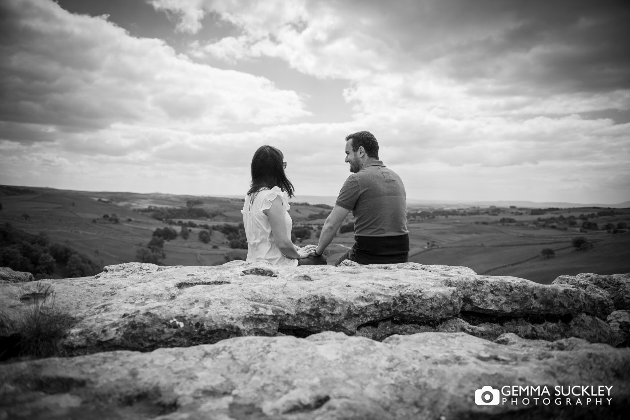 black and white photography of a couple at the top of malham cove