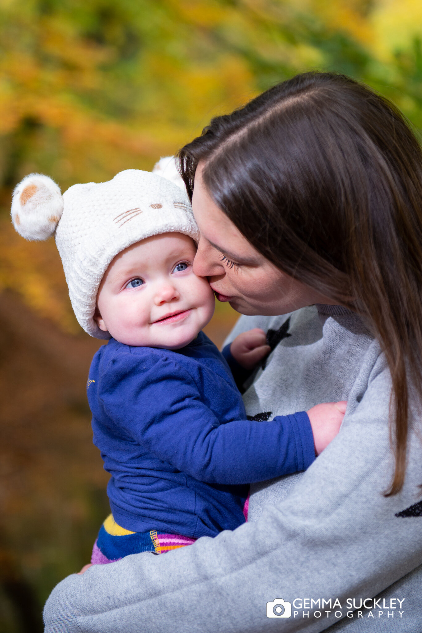 a mum kissing her baby girl during a photo shoot in skipton wood