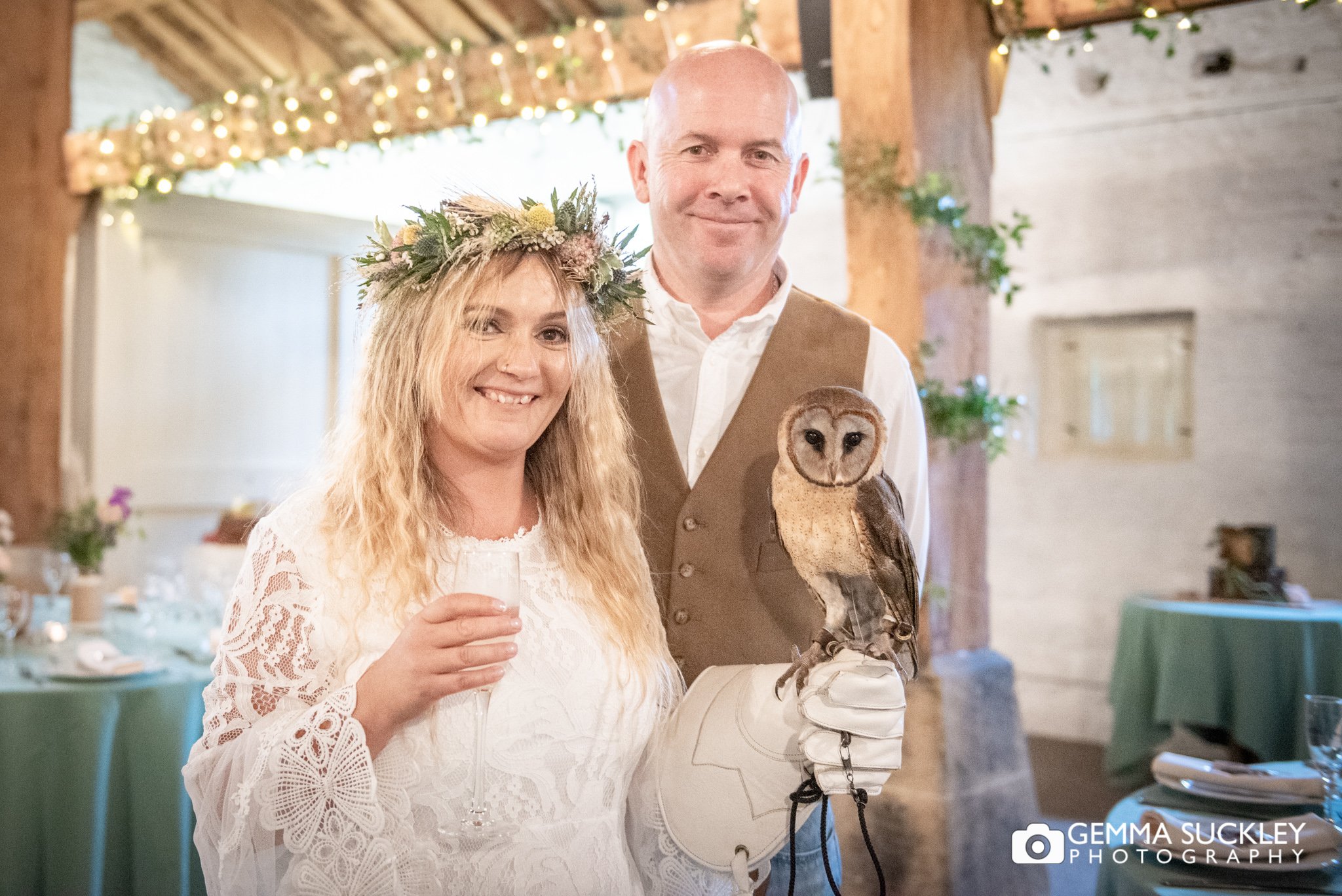 bride and groom posing with an old at east riddlesden hall barn wedding