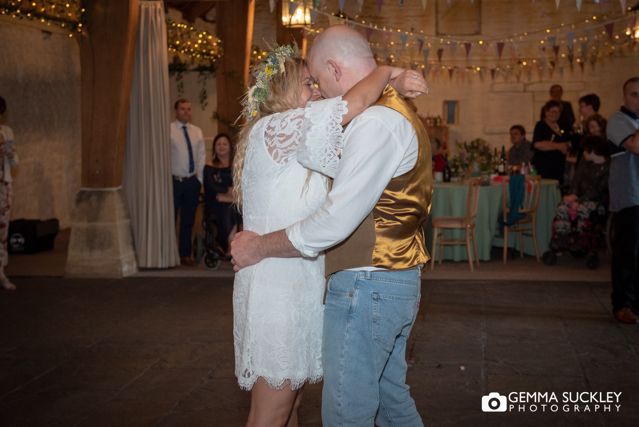 bride and groom kissing during their first dance at east riddlesden hall wedding