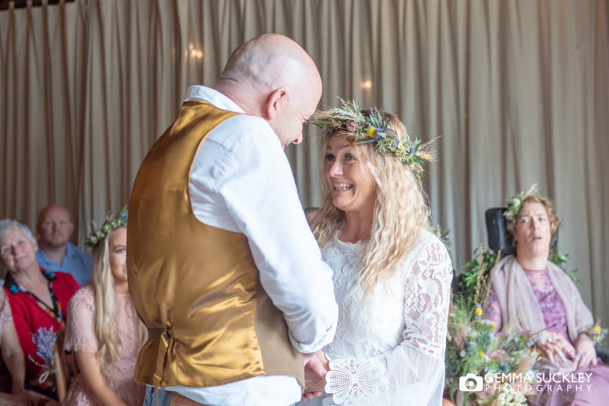the bride and groom laugh as they are pronounced husband and wife at east riddlesden hall 
