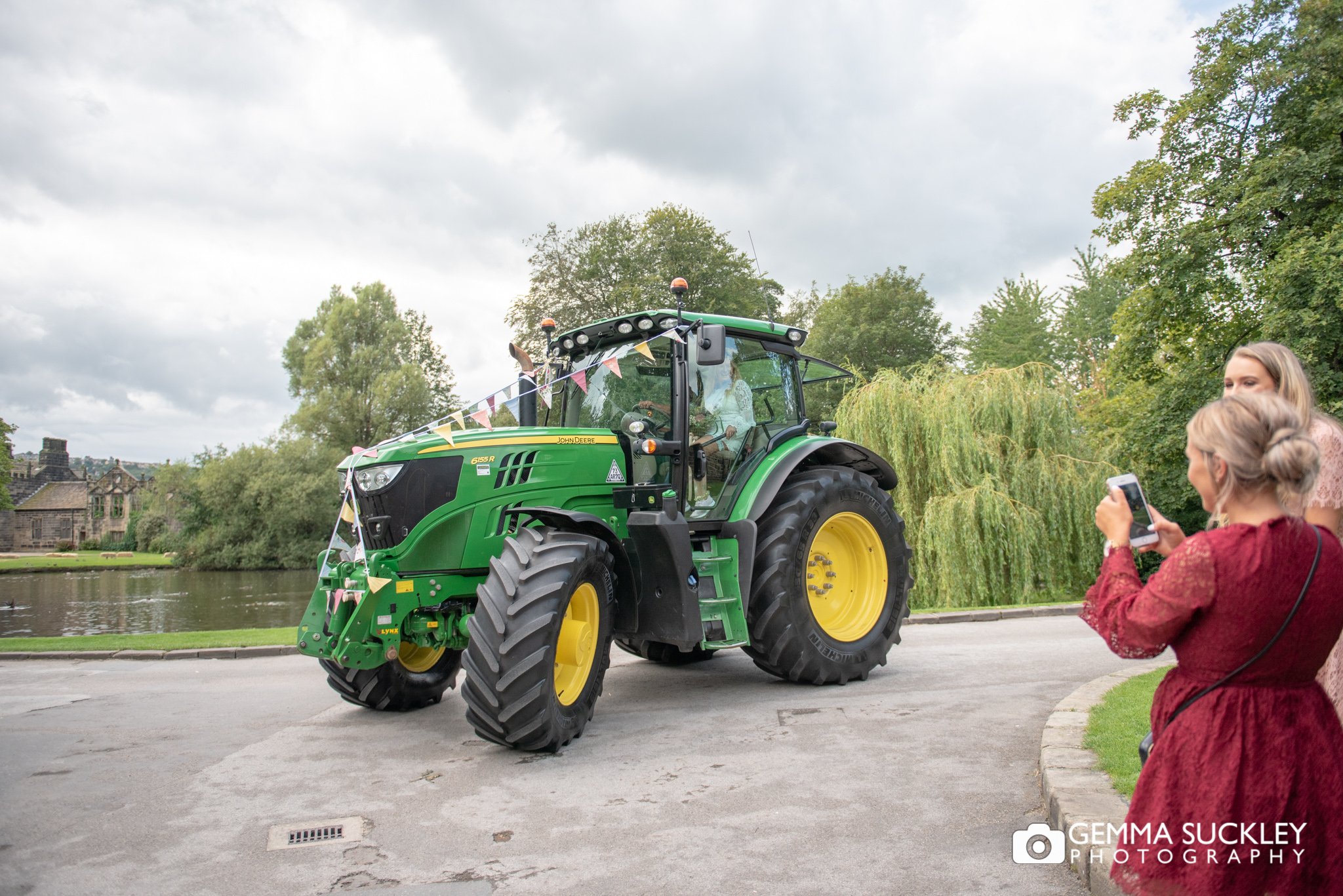a tractor arriving at east riddlesden hall with the bride
