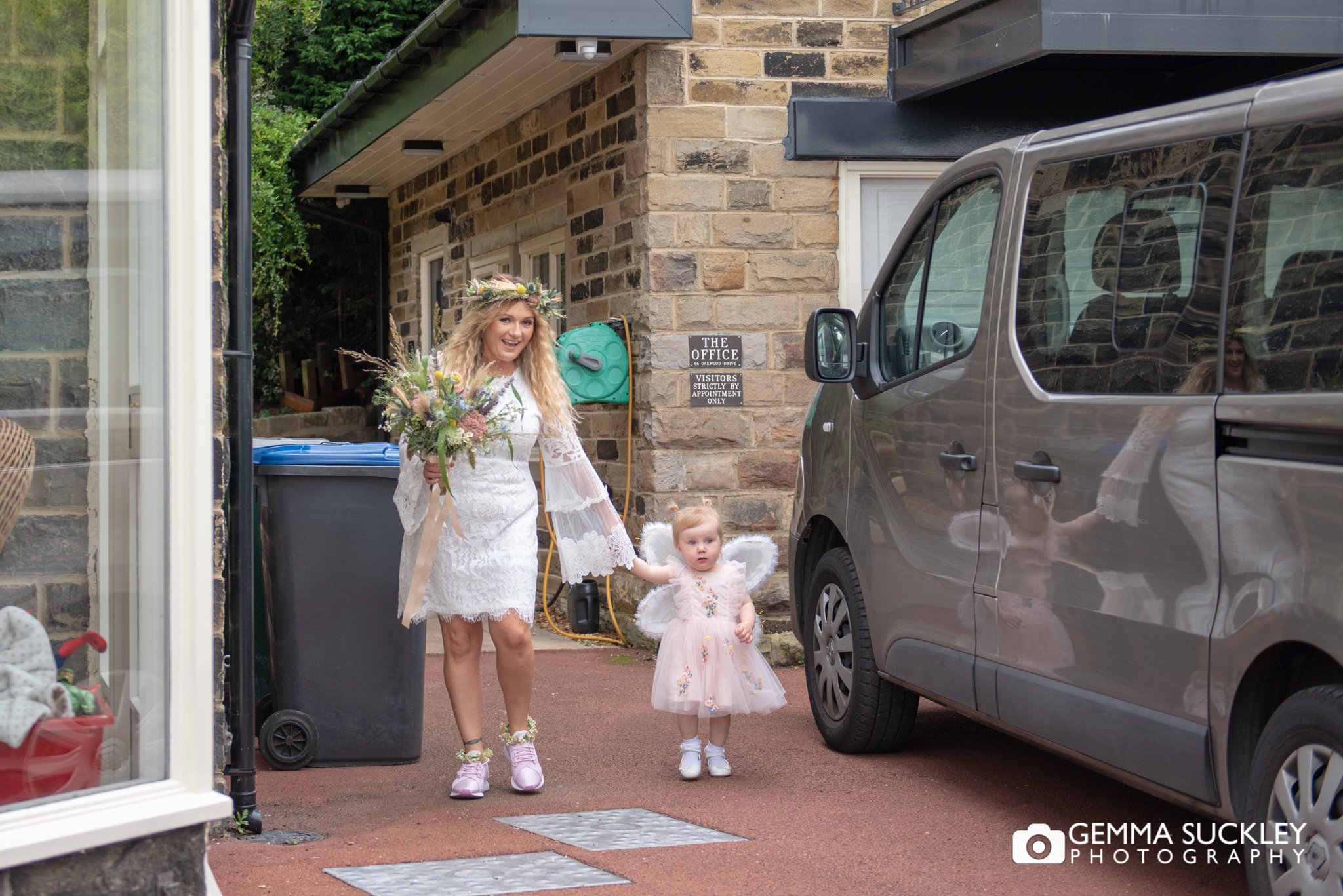 the bride leaving her house in bingley with the flower girl
