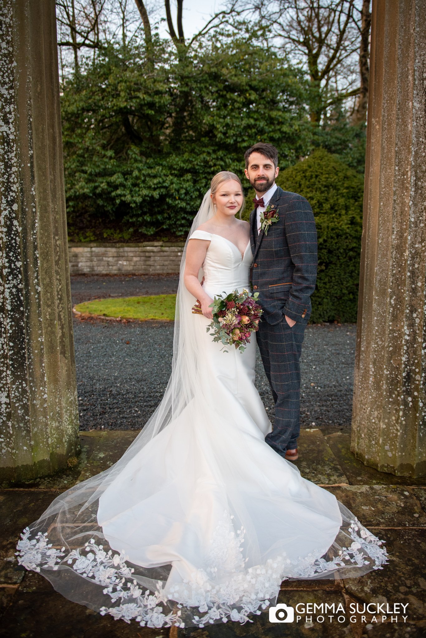 the bride and groom at the ruin in skipton coniston hotel 