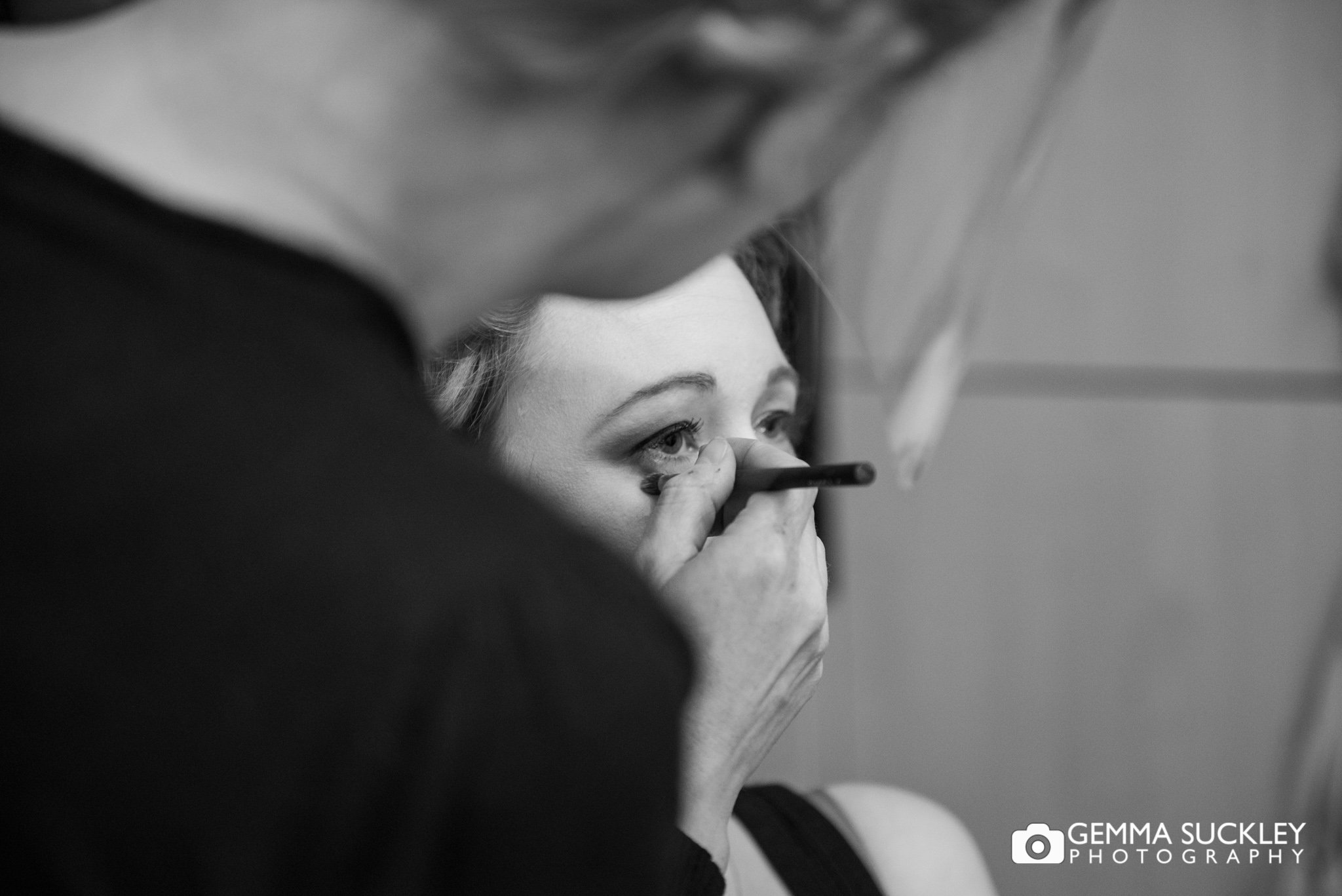 close up photo of a mua applying makeup