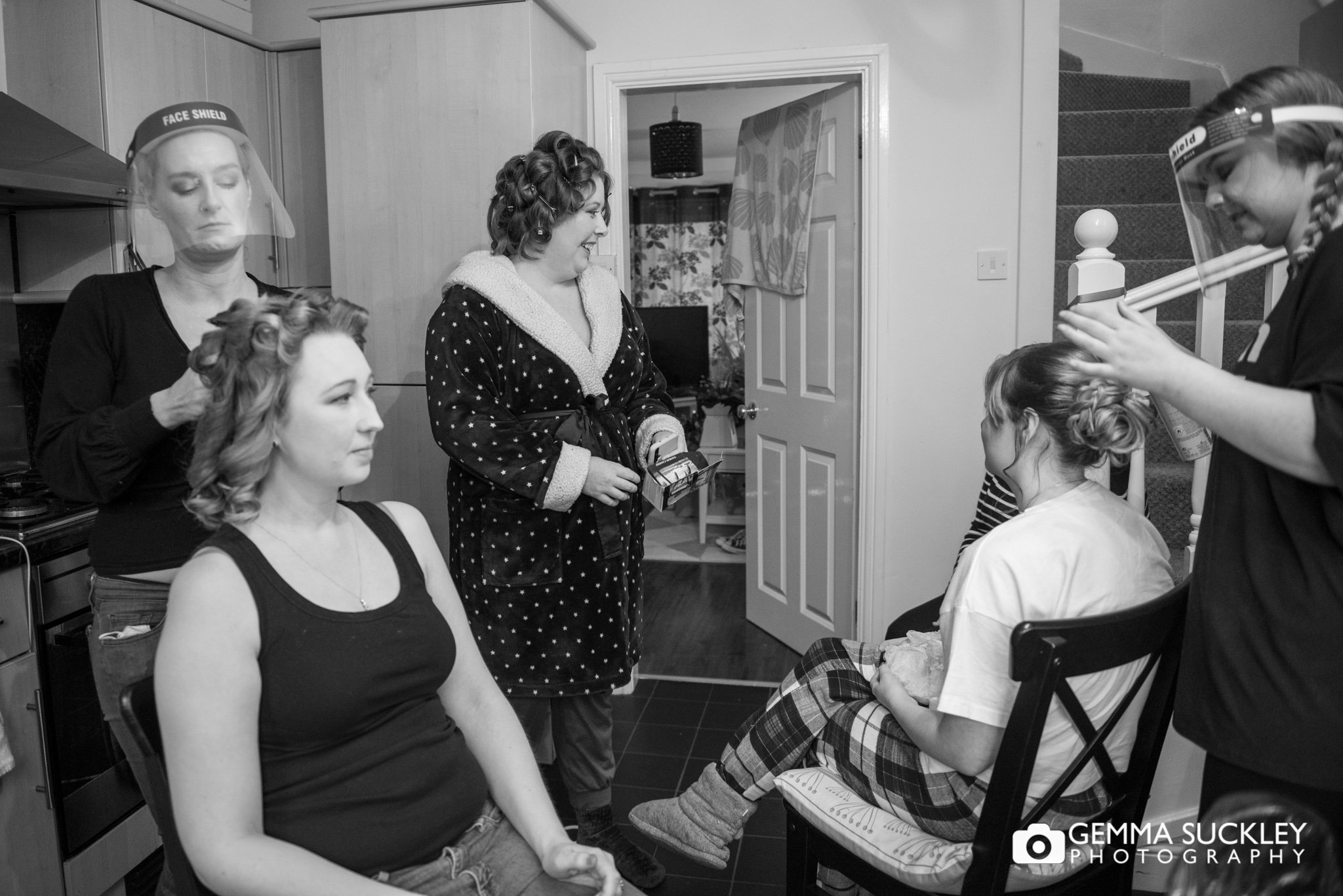 bride and bridesmaids getting their hair done