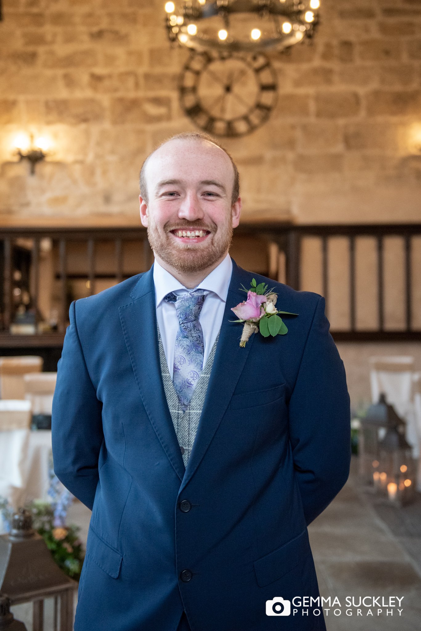 a smiling groom in the priests house and old chapel 