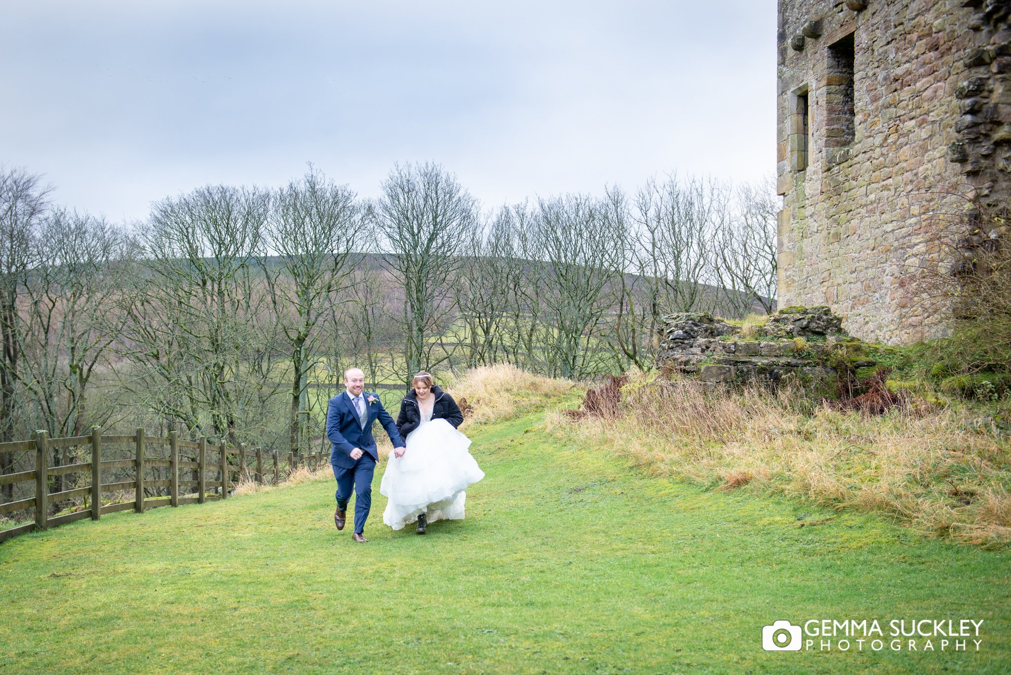 the bride and groom running outside barden tower