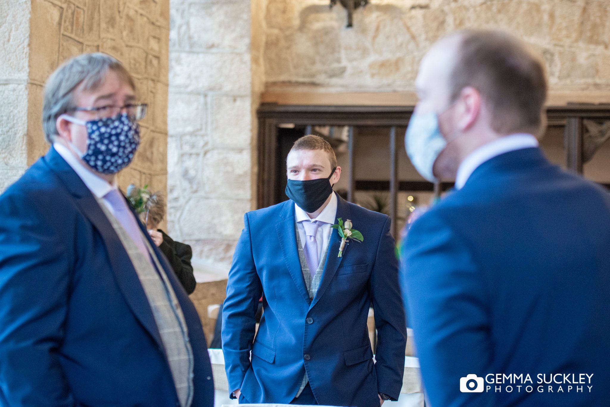 the groomsmen stood in mask at the priests house