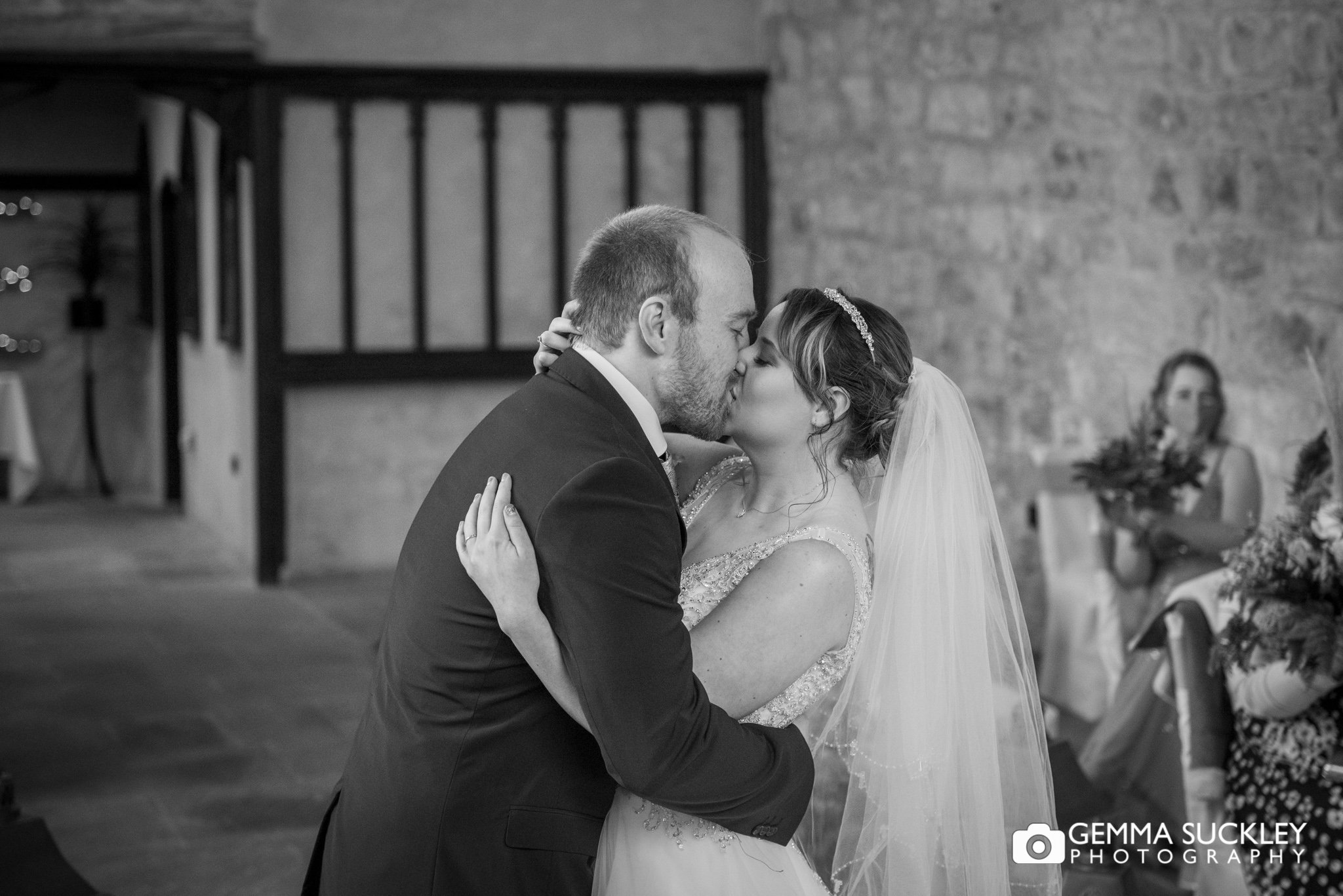 the bride and groom kissing at the priests house at bolton abbey