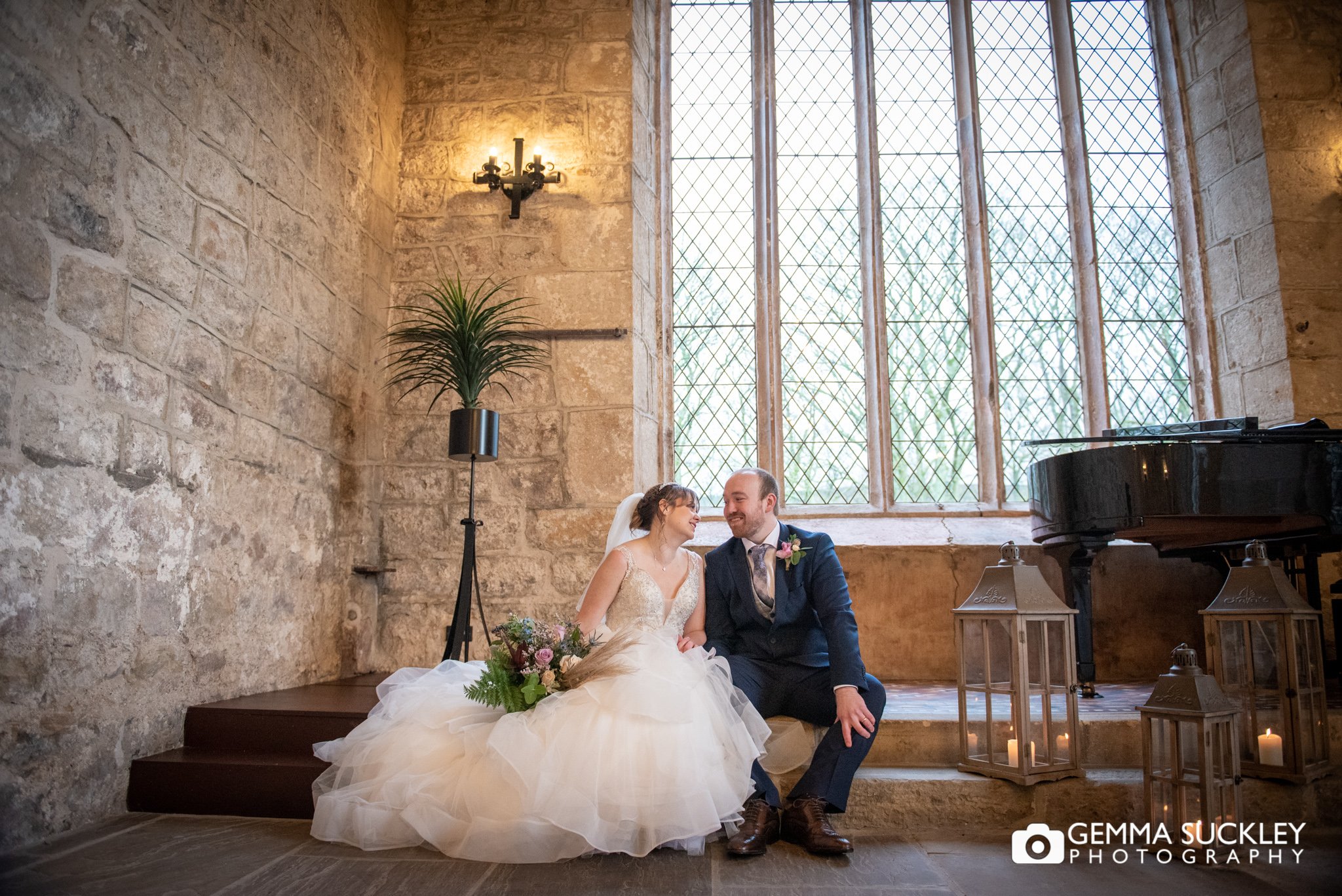 couples wedding portrait by the window at the priests house and old chapel