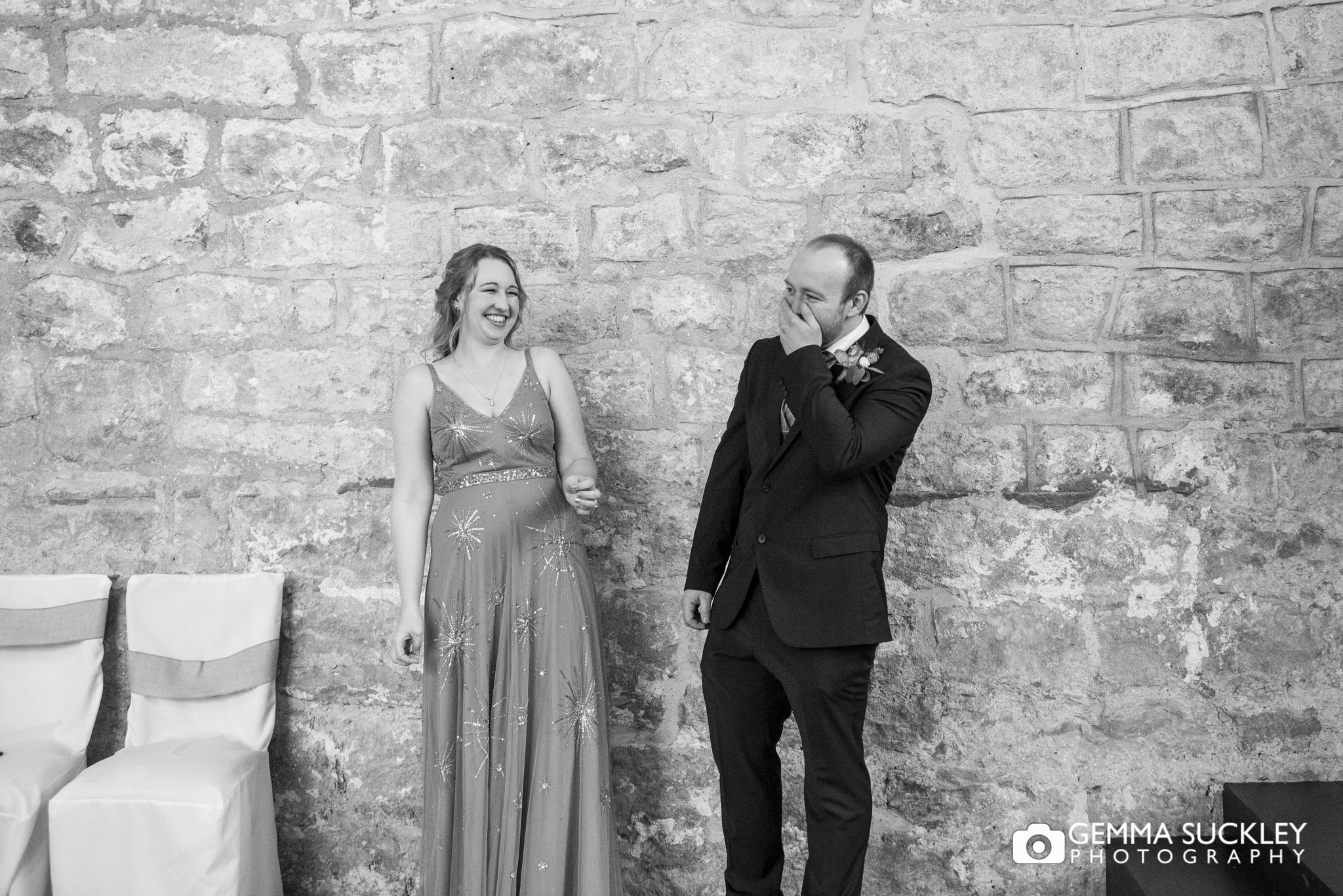 the groom laughing with his sister in the priests house in bolton abbey