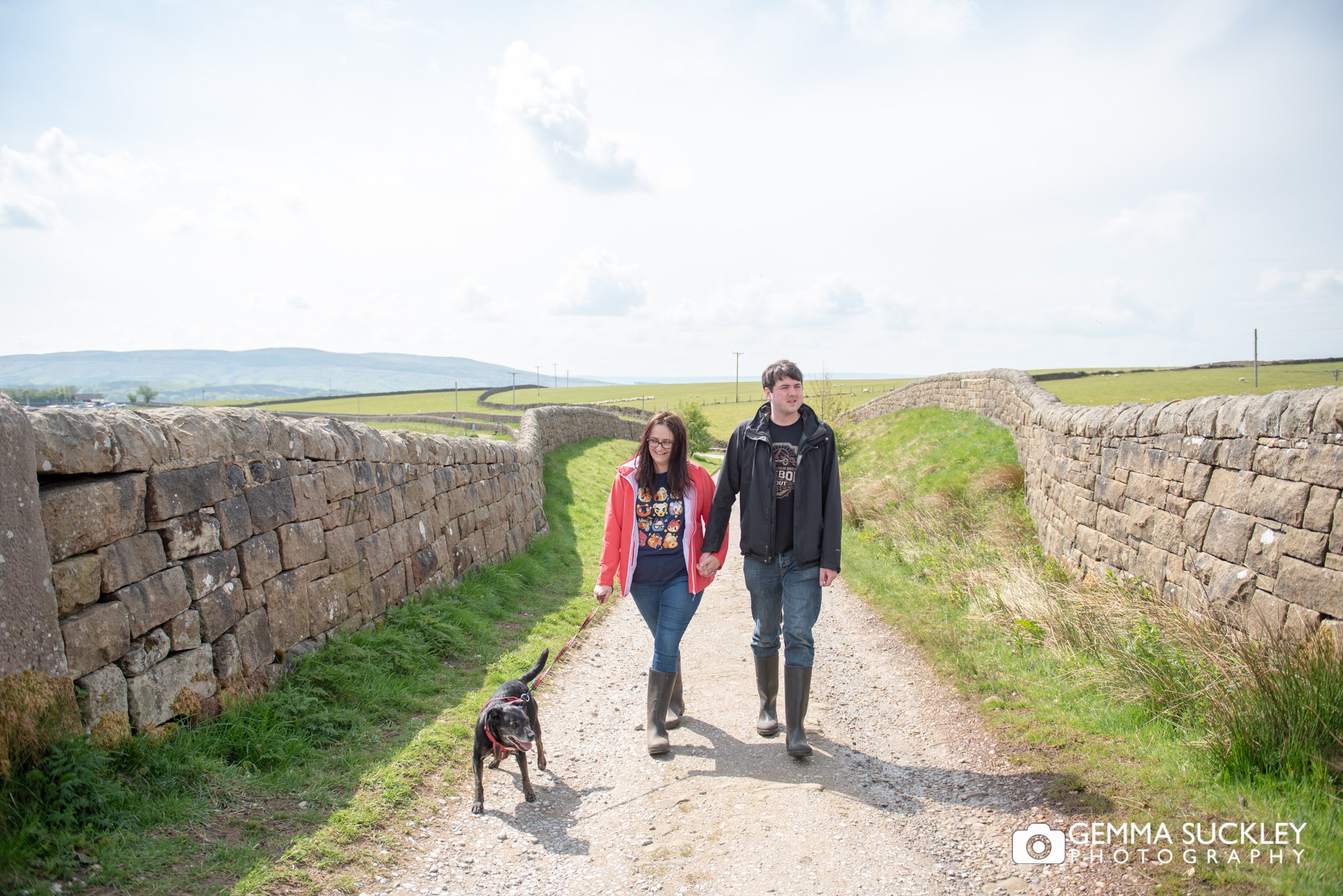 a couple walking at embsay reservoir with their dog