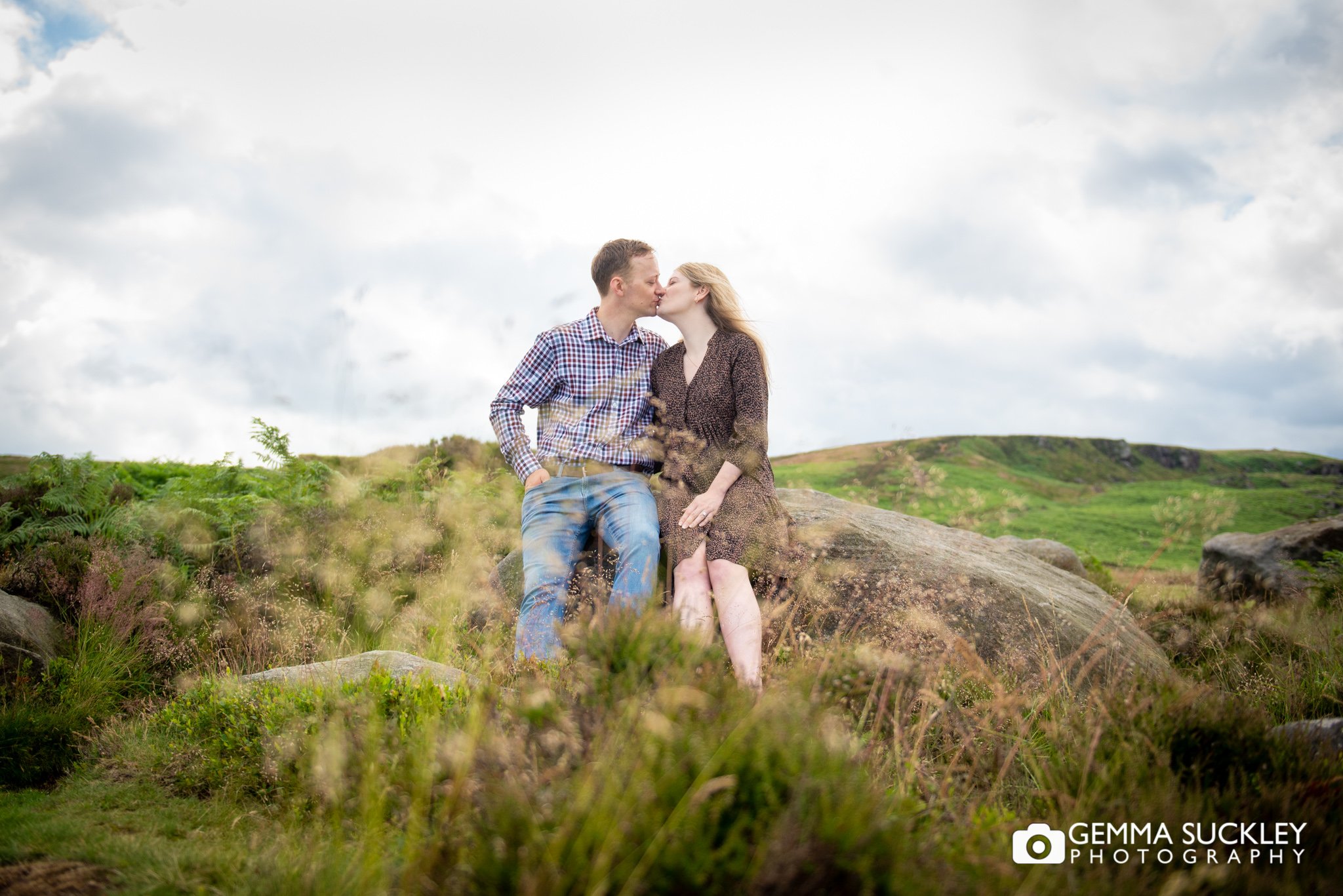 newly engaged couple kissing on ilkley moor