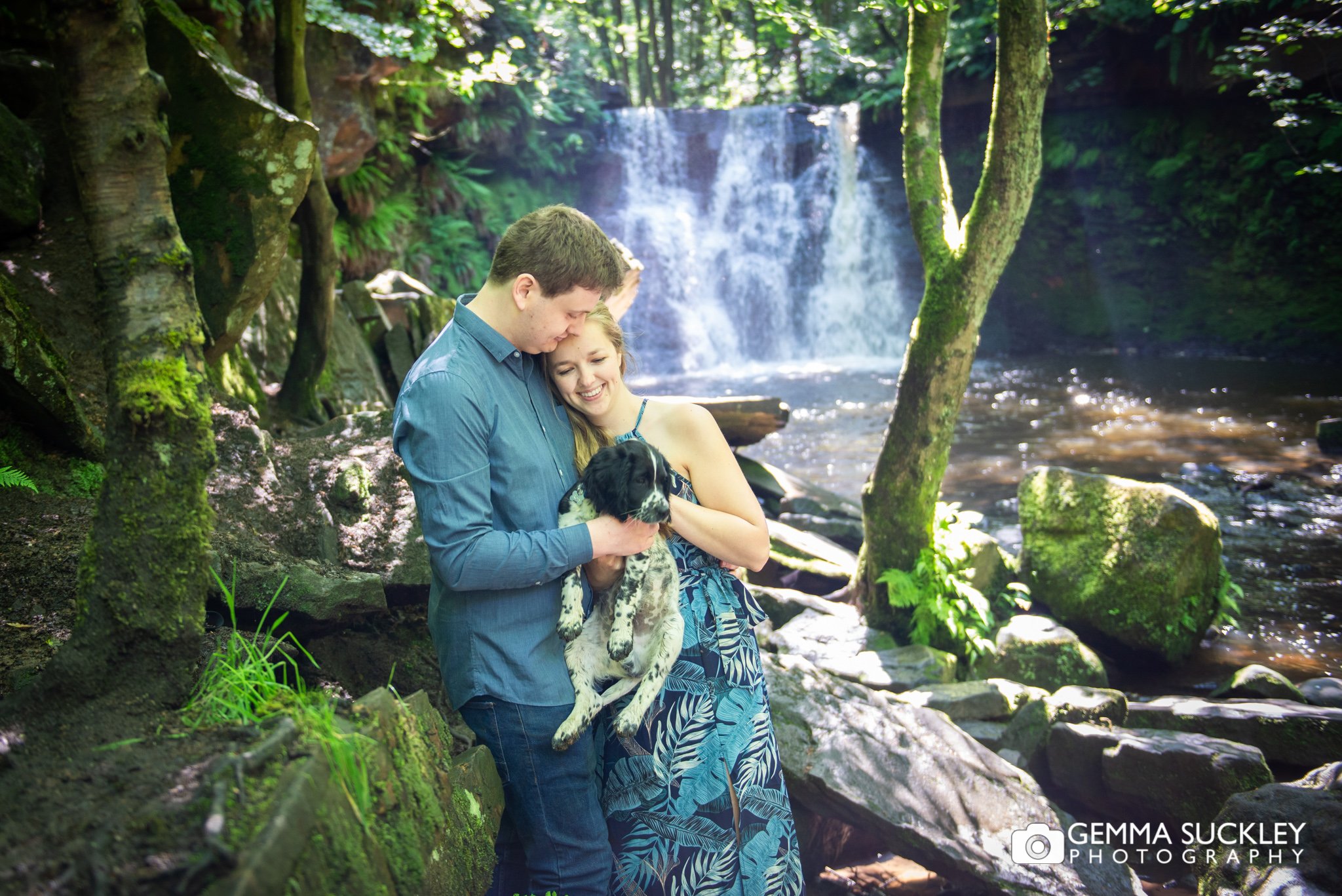 engagement photo of a couple and their puppy at goitstock waterfall