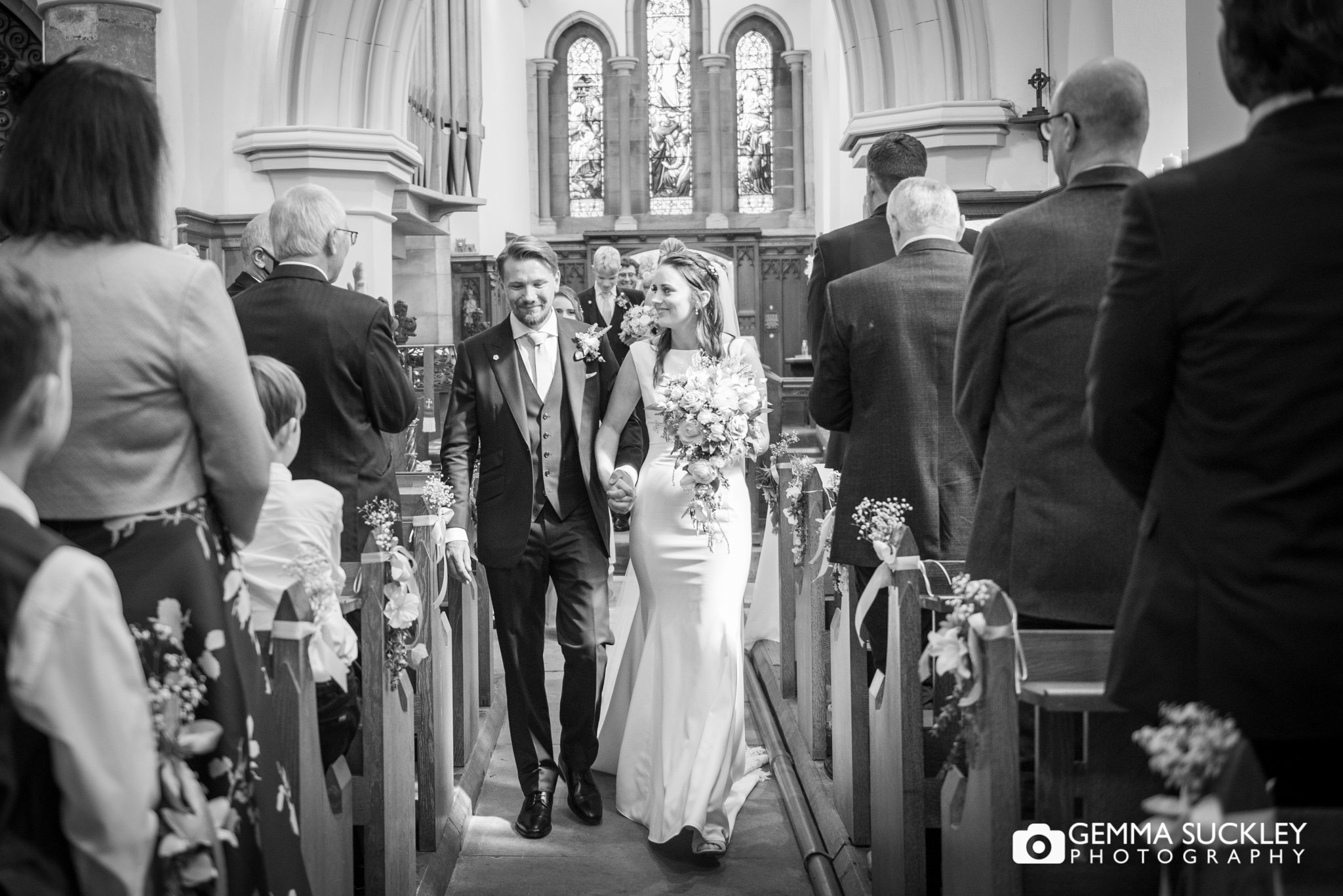 just married couple walking down the aisle at wetherby church