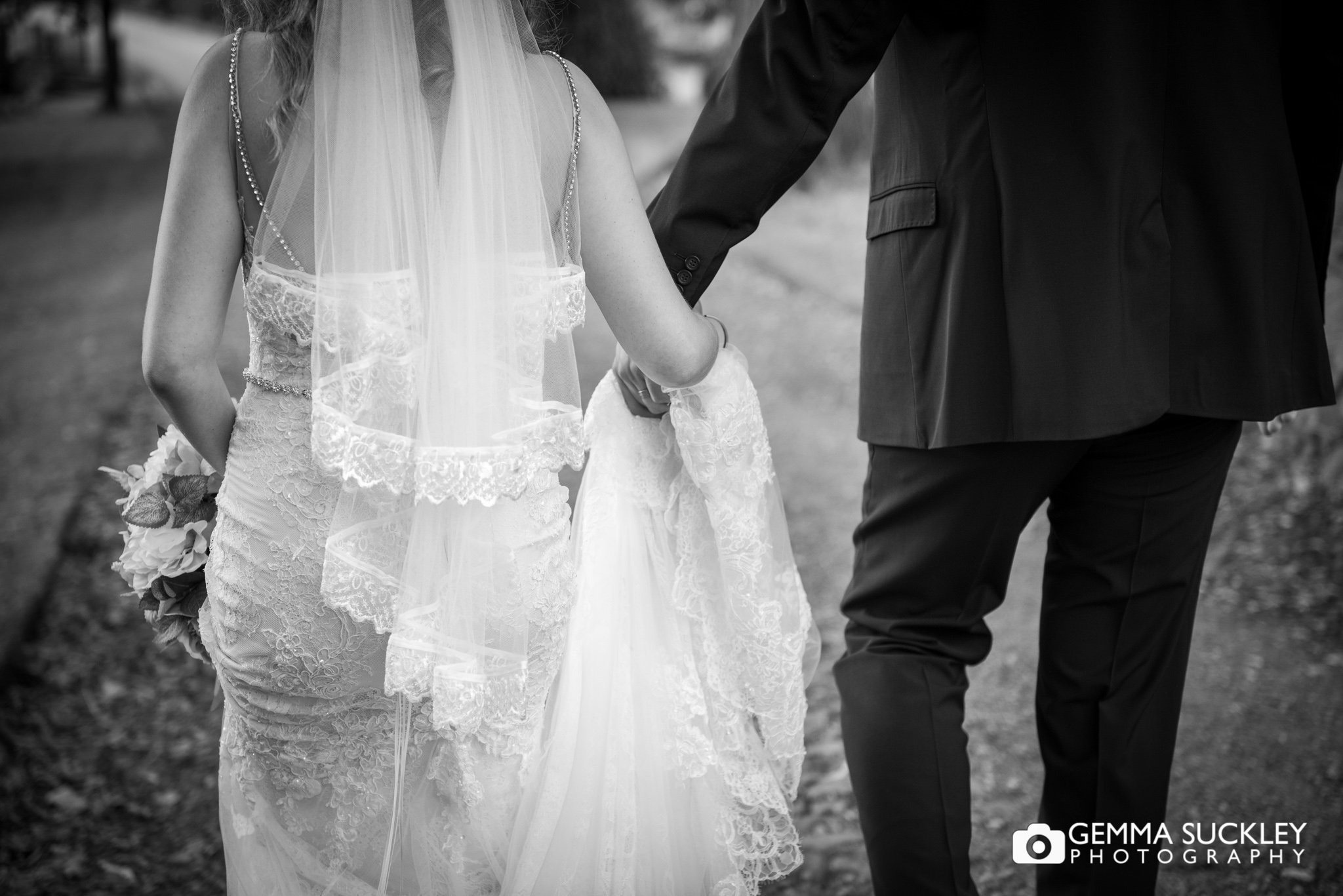 wedding photography of the bride and groom walking