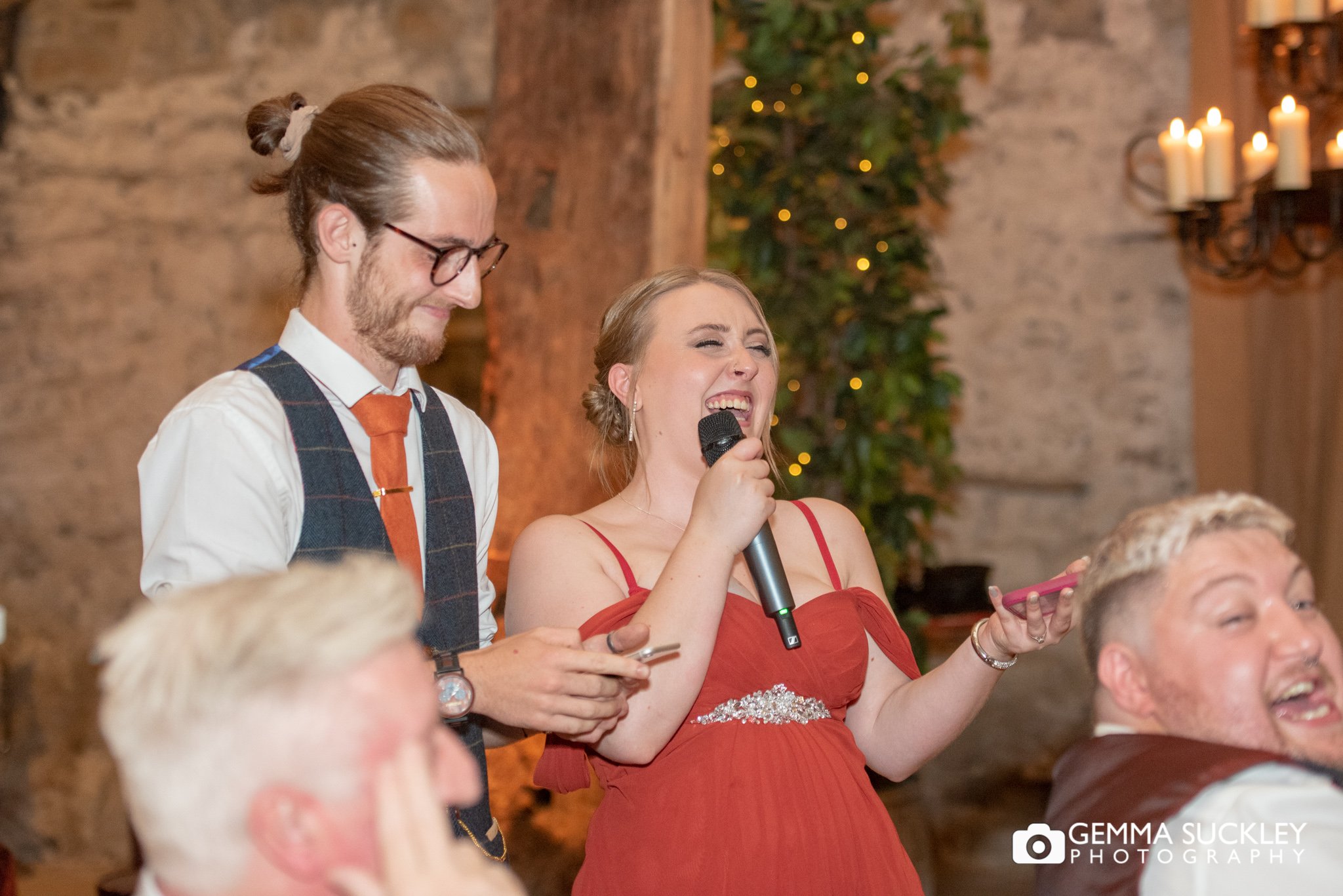 bridesmaid and grooms man laughing during speeches at the tithe barn