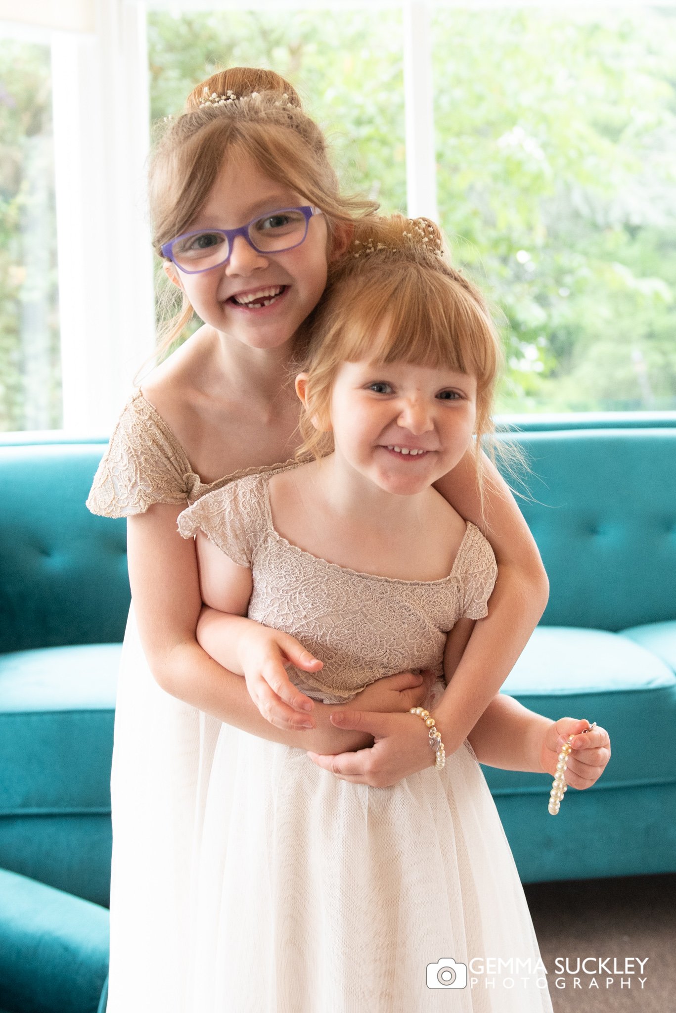 flower girls hugging for a wedding portrait