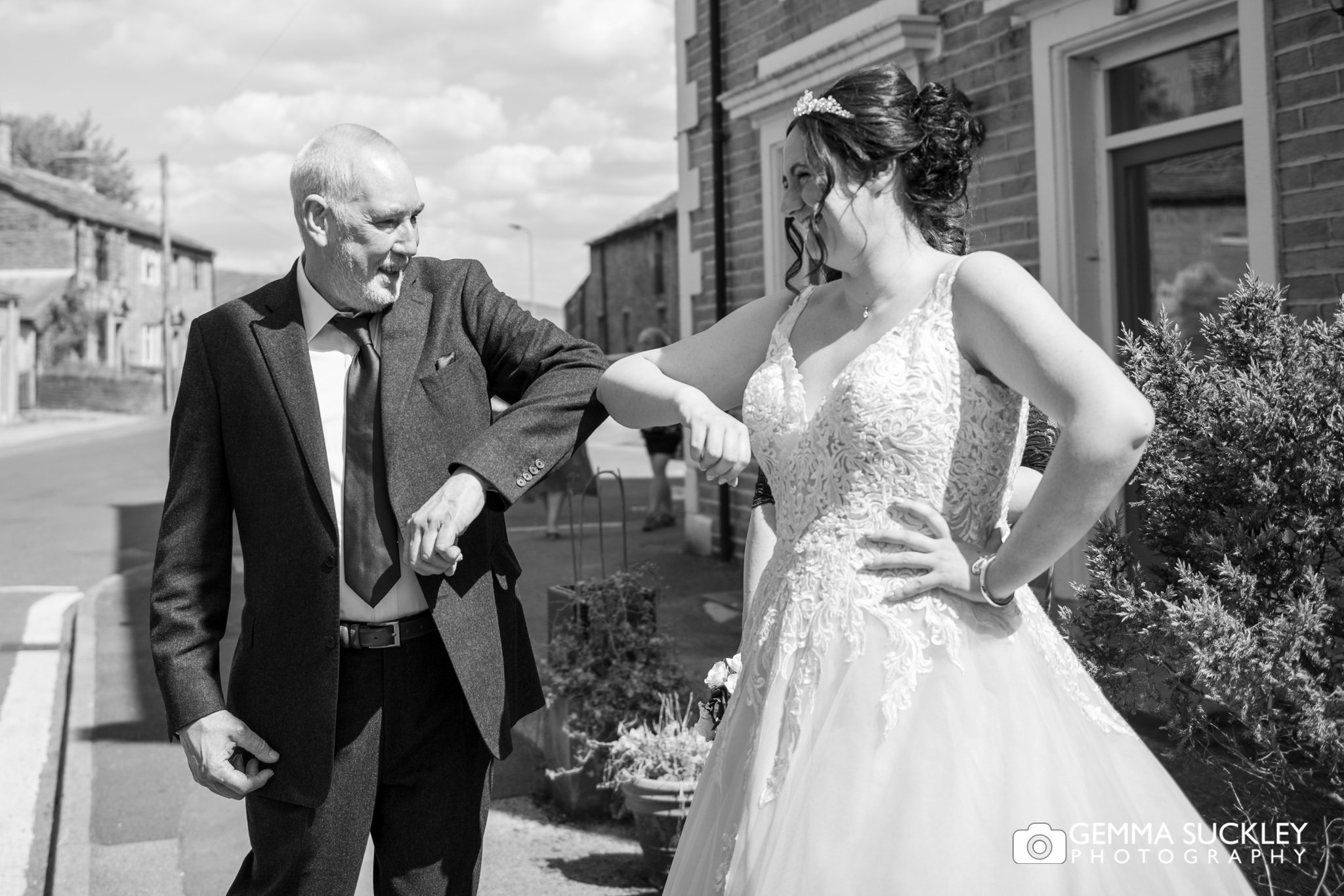 bride and dad touching elbows during a pandemic wedding
