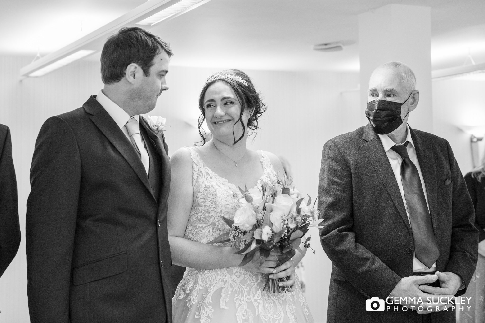 black and white wedding photo of the bride and groom during their wedding ceremony at skipton registry office