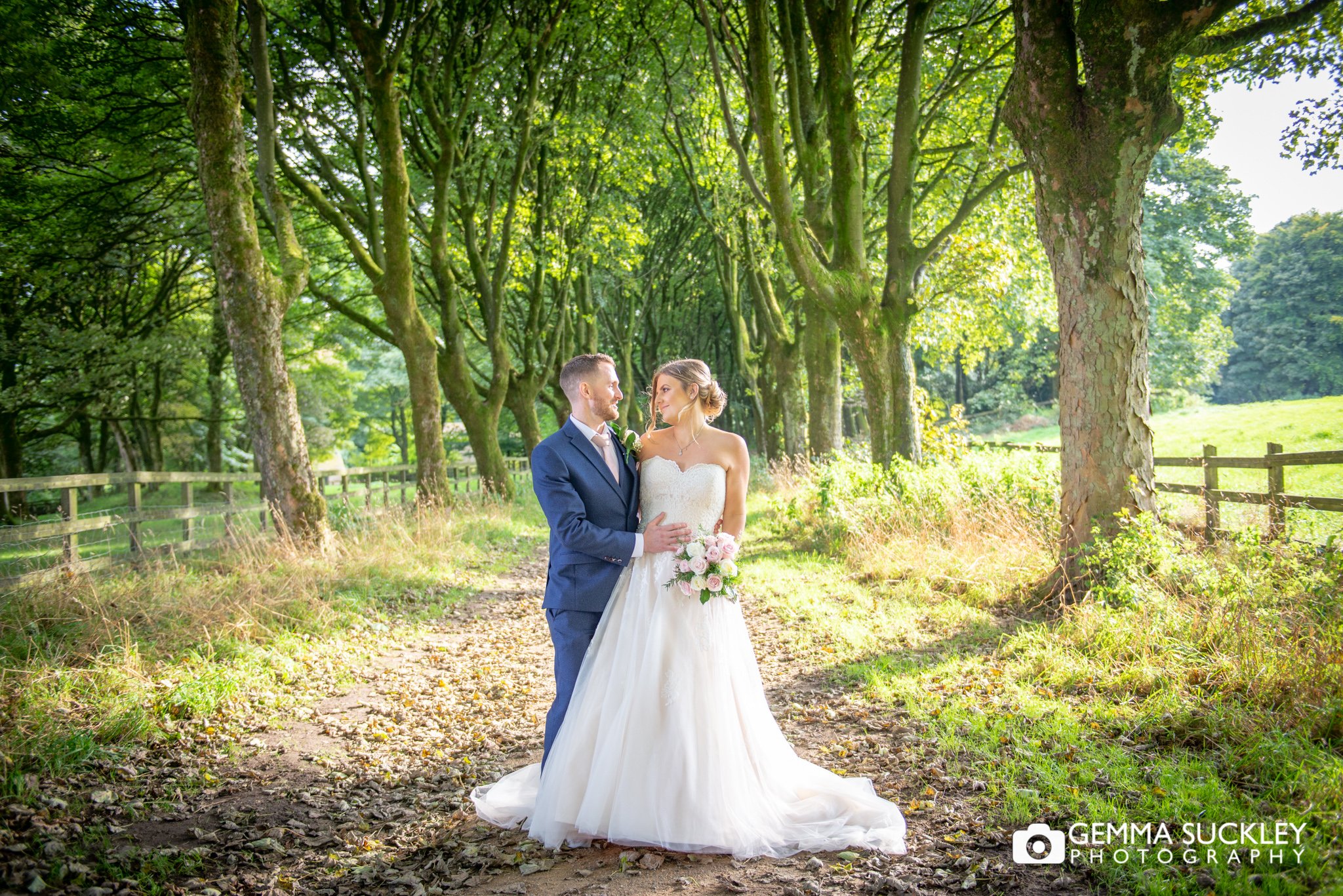 natural wedding portrait of newly wed couple in the woods