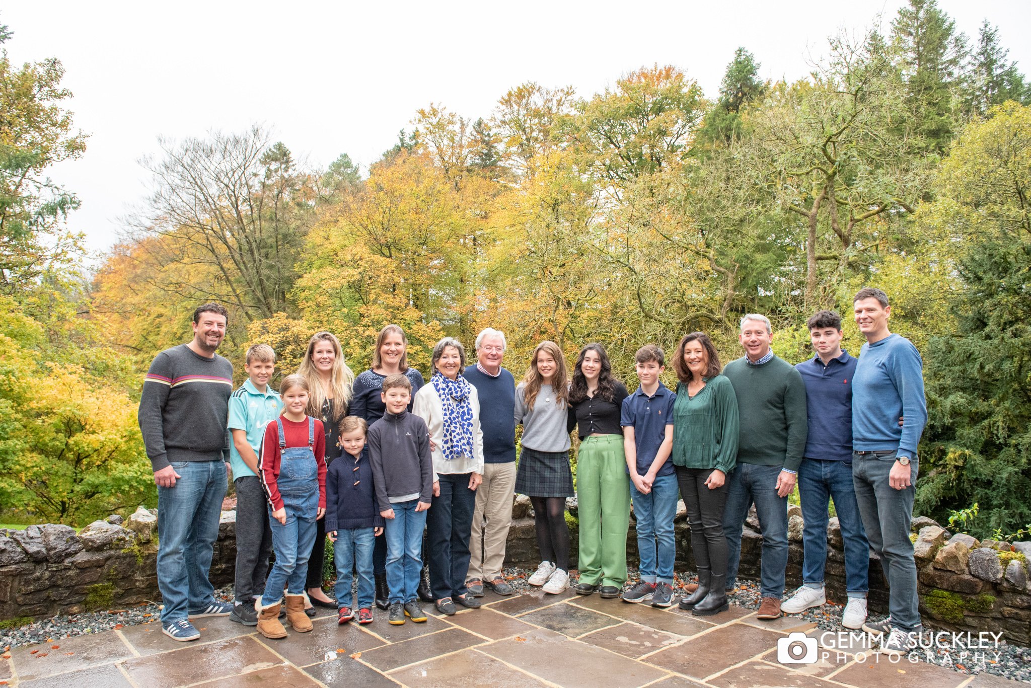 family group photo at oughtershaw hall with autumn trees behind