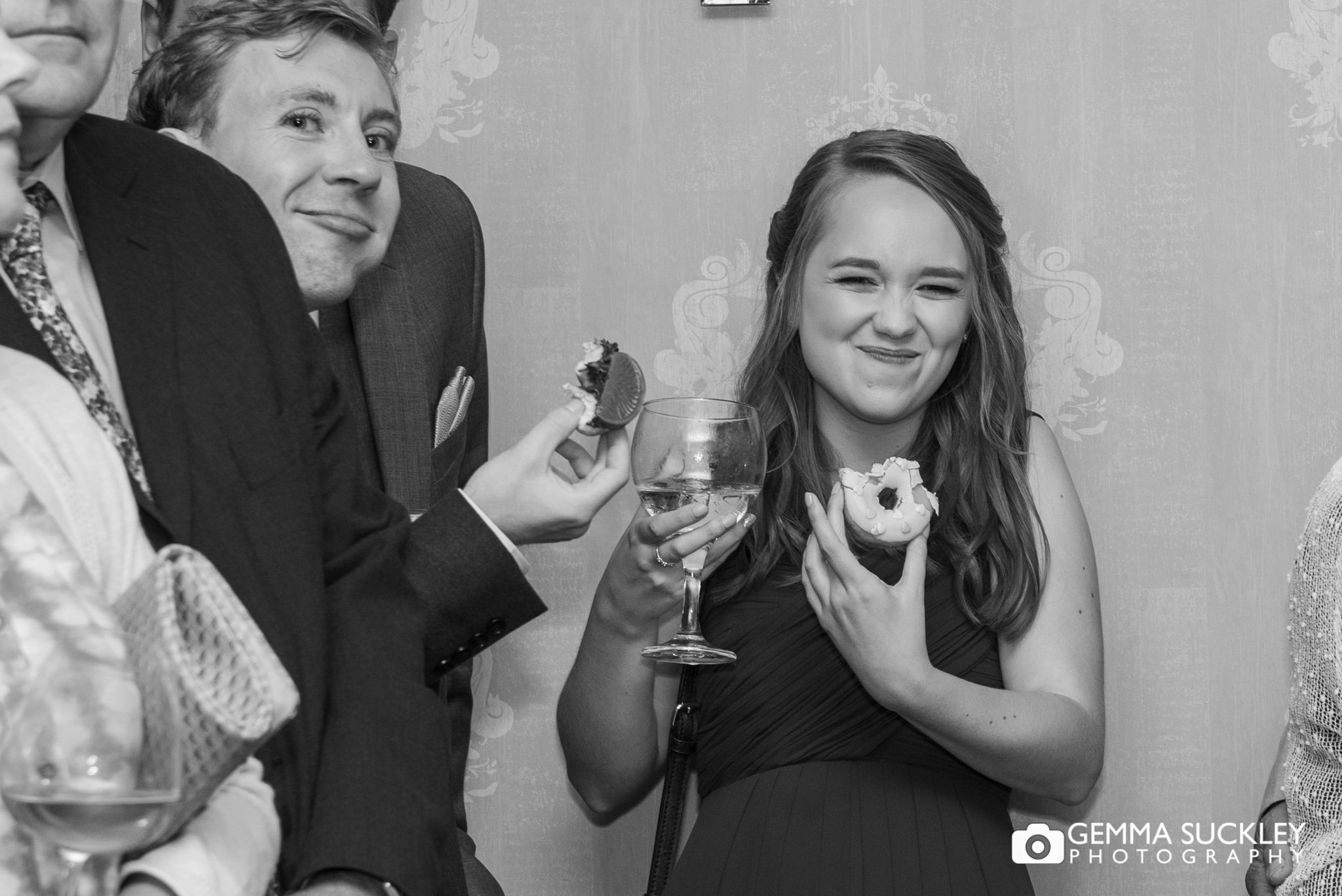 a bridesmaid caught eating a doughnut during the first dance