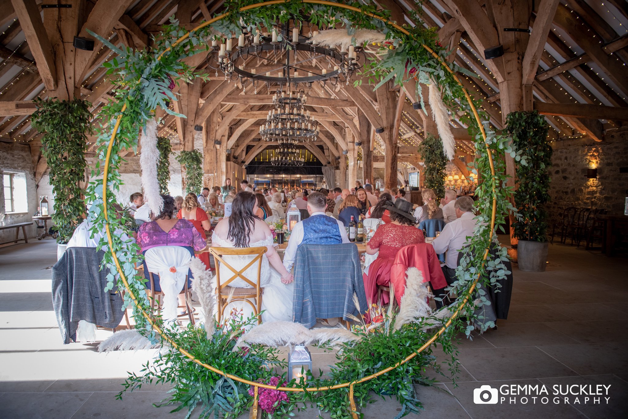 the tithe barn in bolton abbey shot through a floral ring 