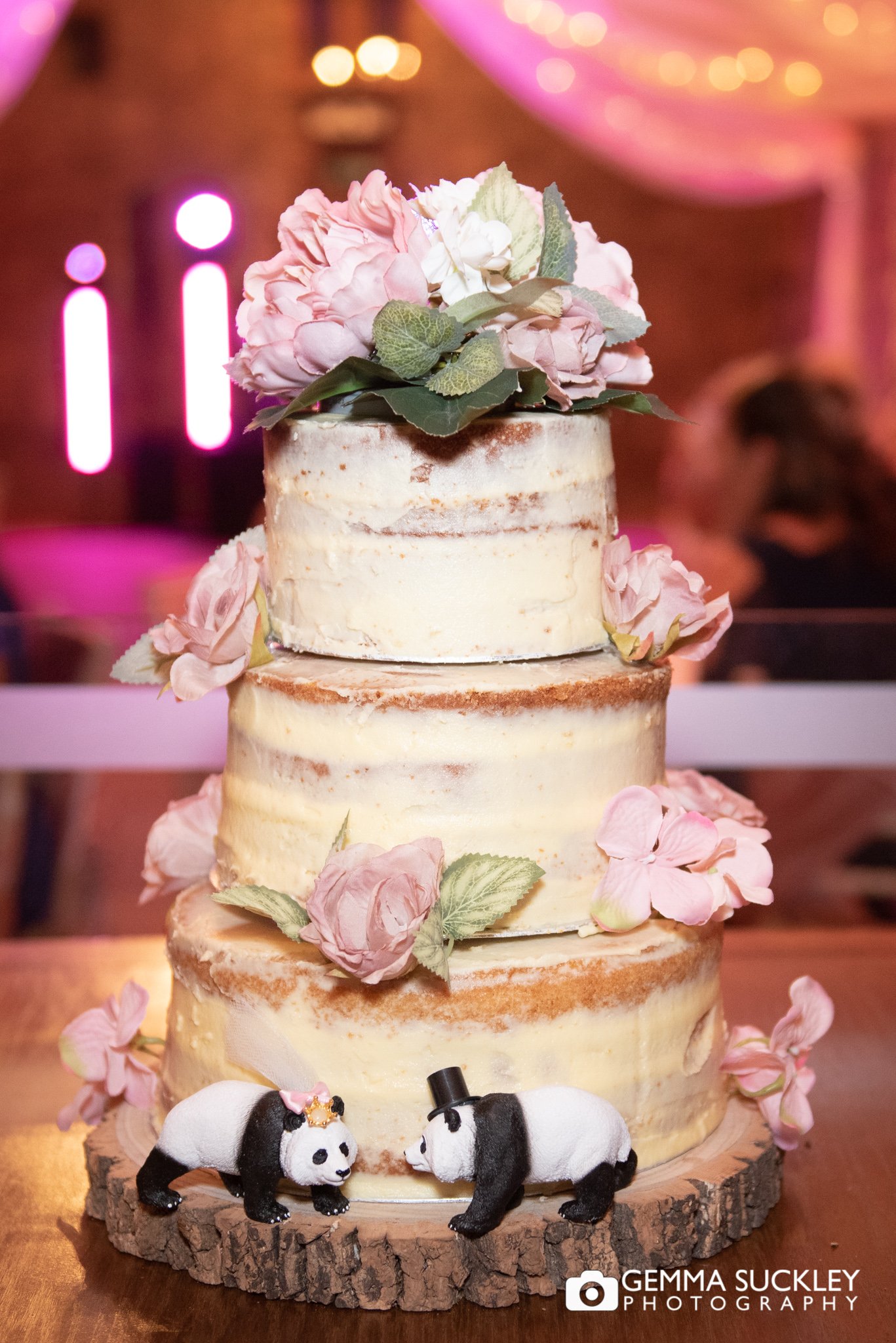 wedding cake with two panda decorations