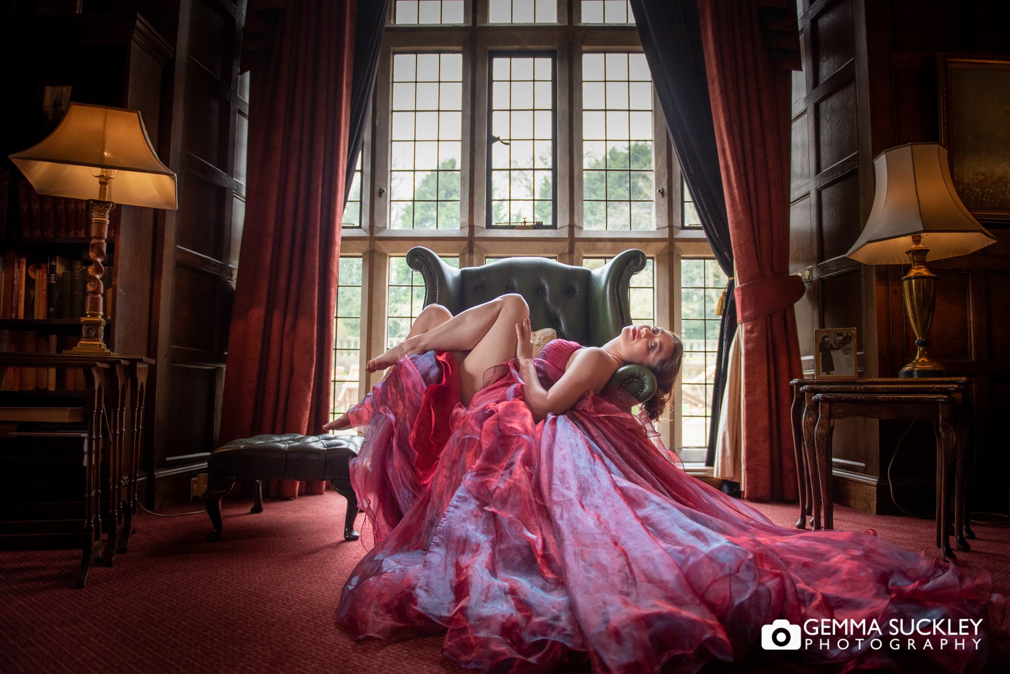 a model in a flowing red dress at goldsborough hall 