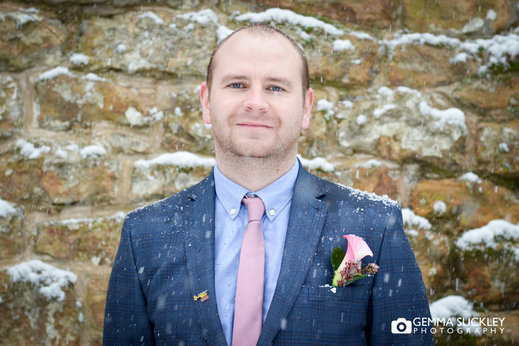 groom wedding portrait in the snow at skipton