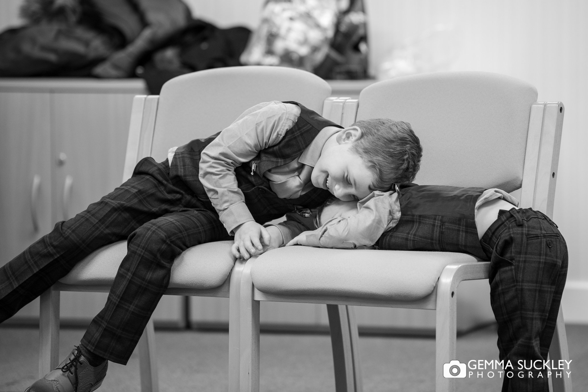 two pageboys playing at skipton registry during the wedding ceremony