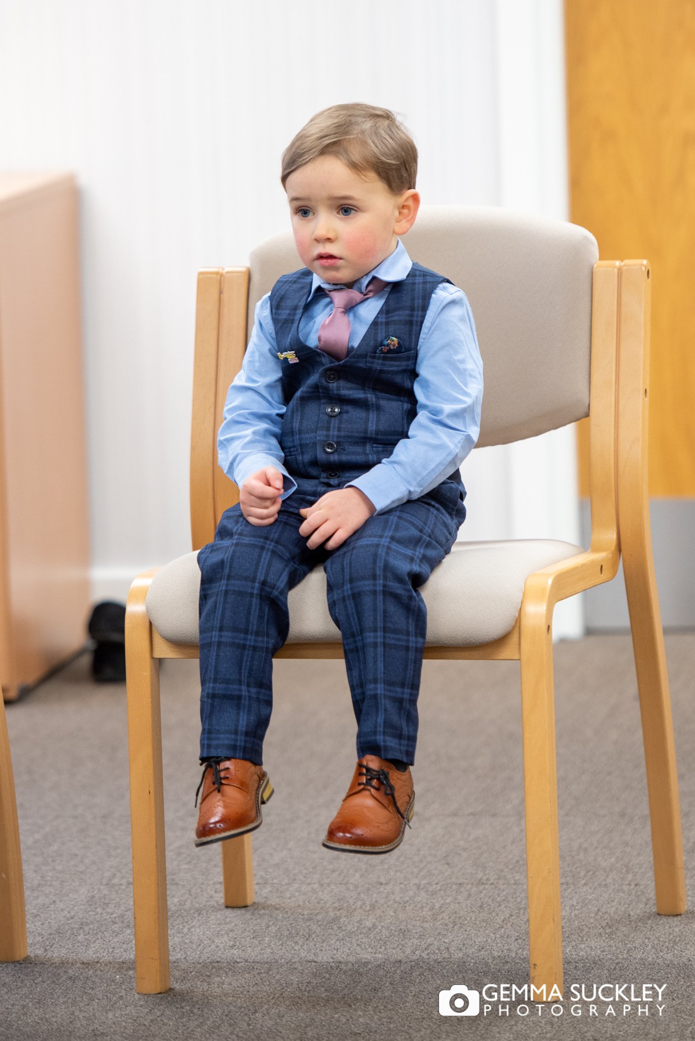 a young pageboy watches his mum and dad getting married