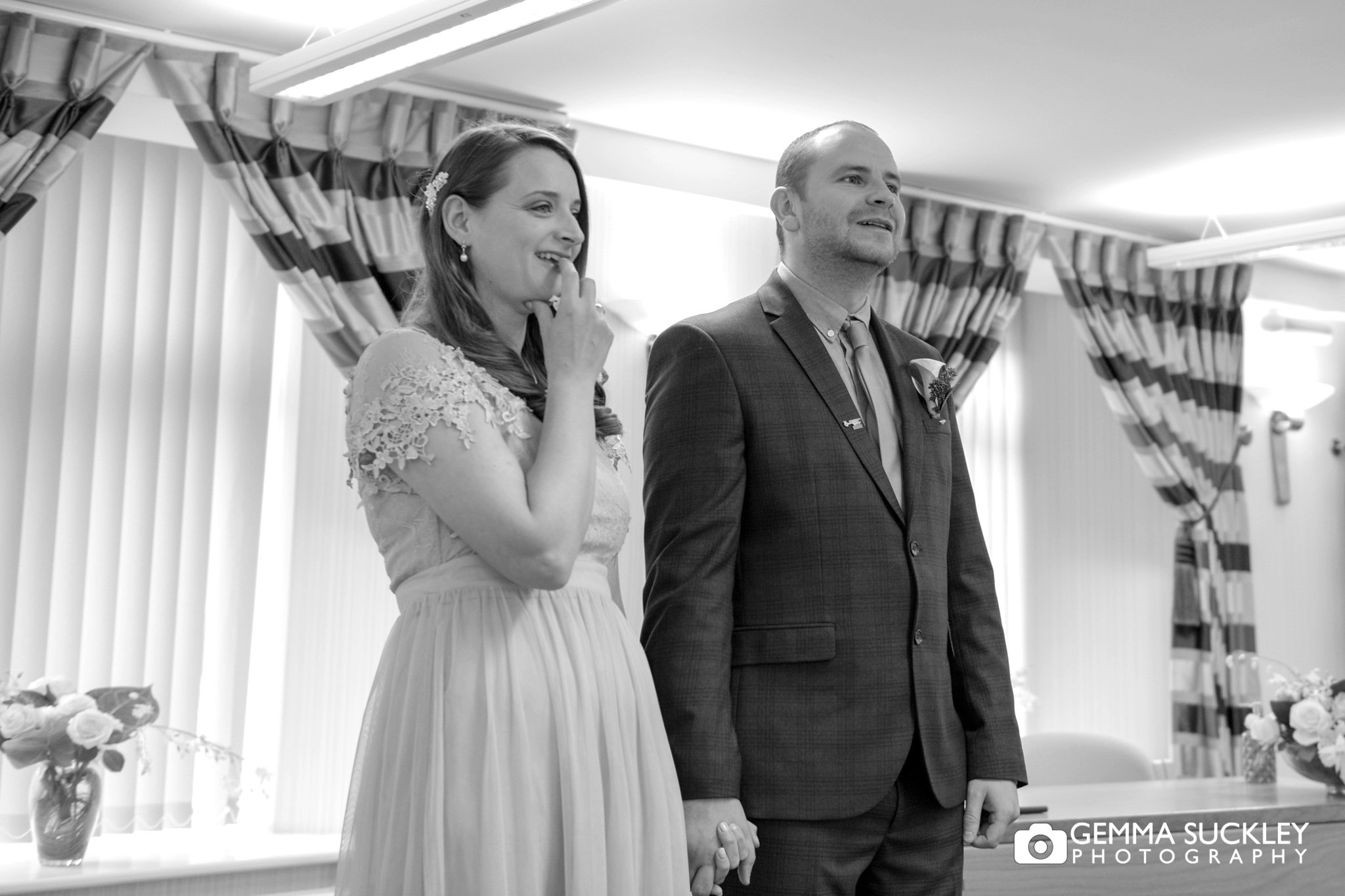 bride and groom looking nervous during their wedding ceremony at skipton registry office