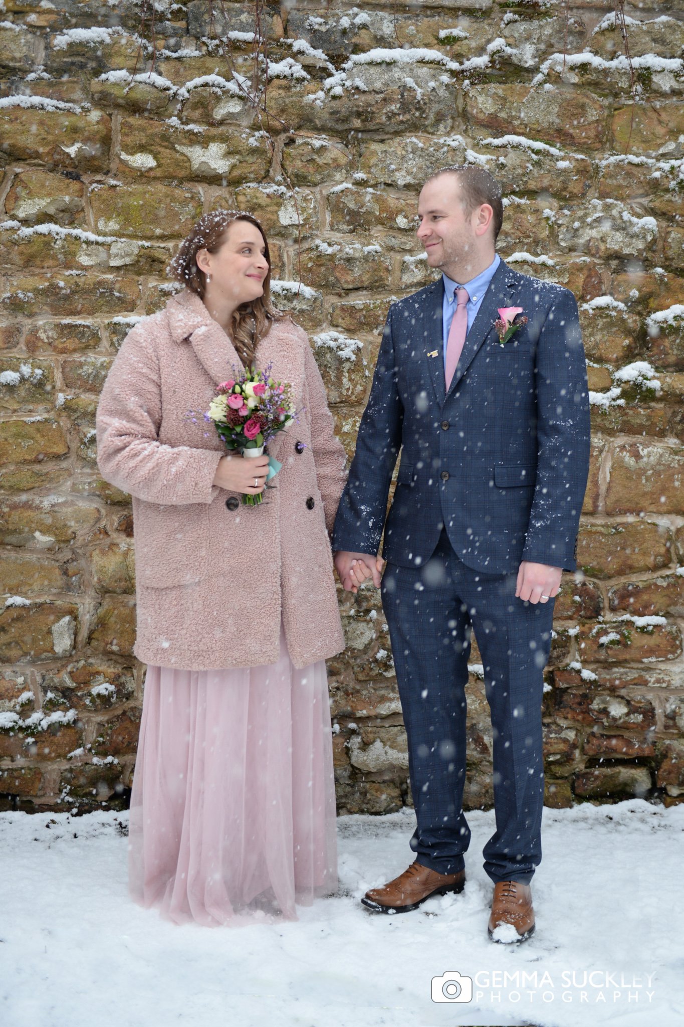 wedding photo of the bride and groom in the snow in skipton