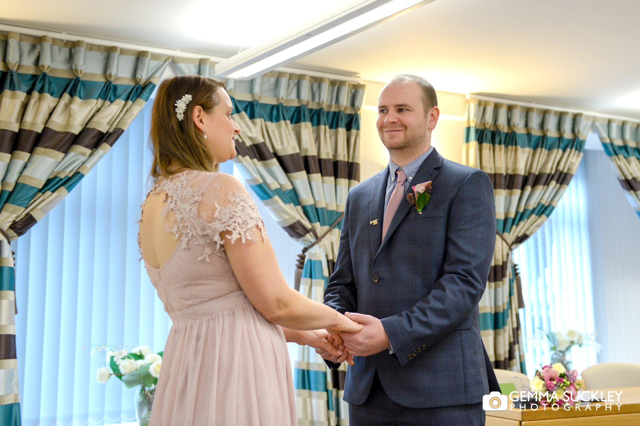 wedding photography of the bride and groom saying their vows at skipton registry office
