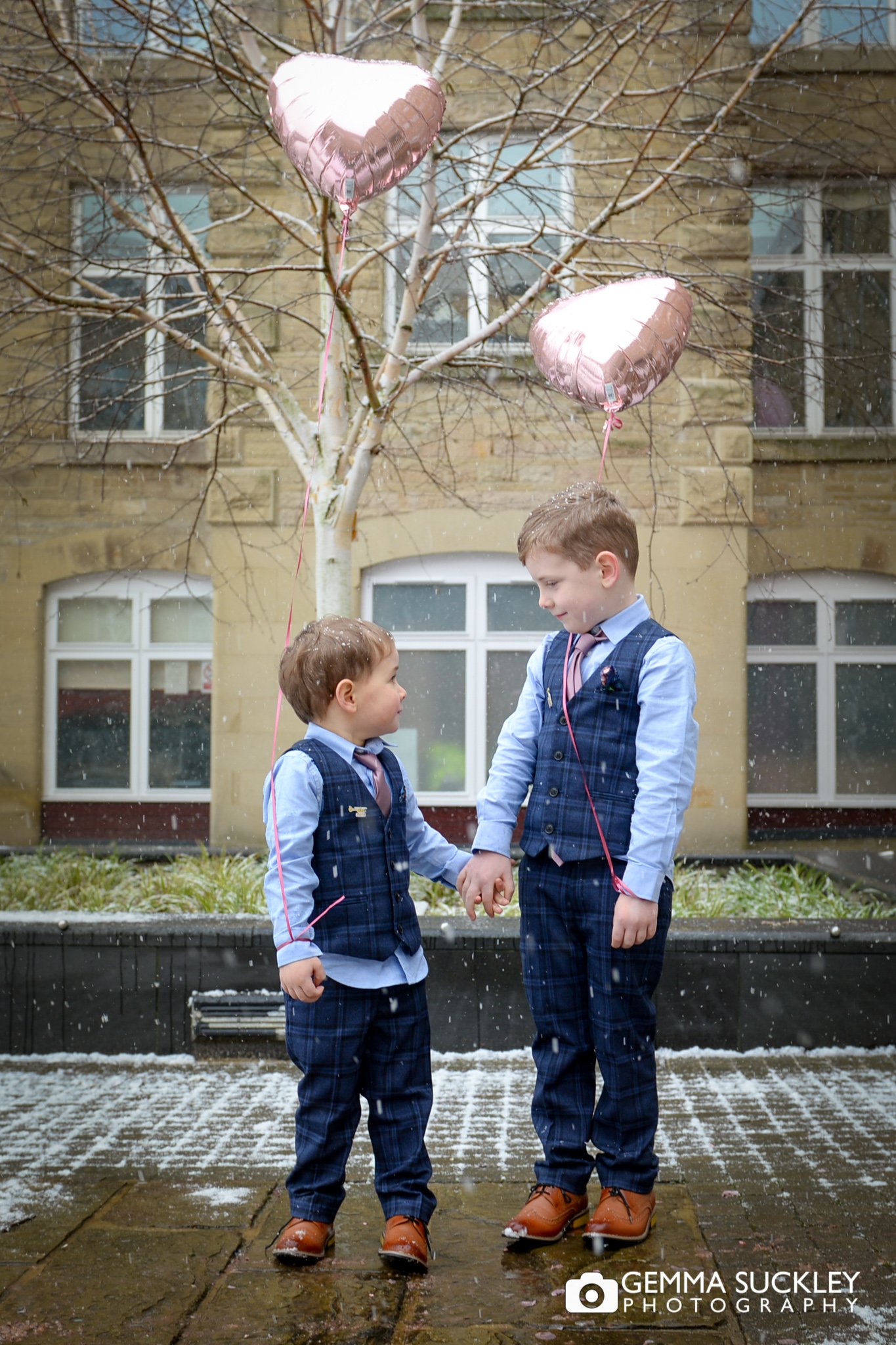 wedding portrait of two pageboys holding heart balloons at skipton registry office