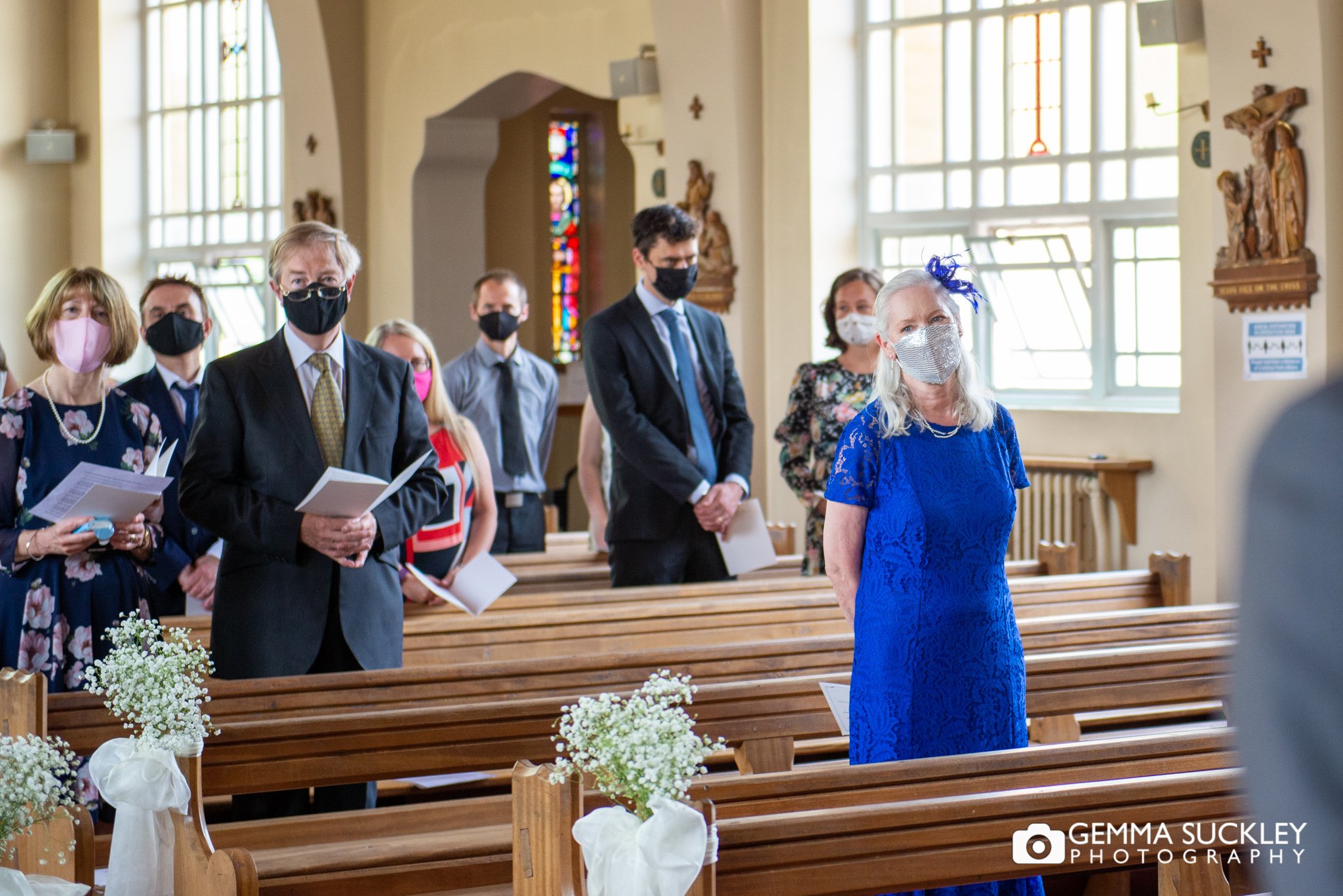 wedding guest socially distanced wearing marks in a church