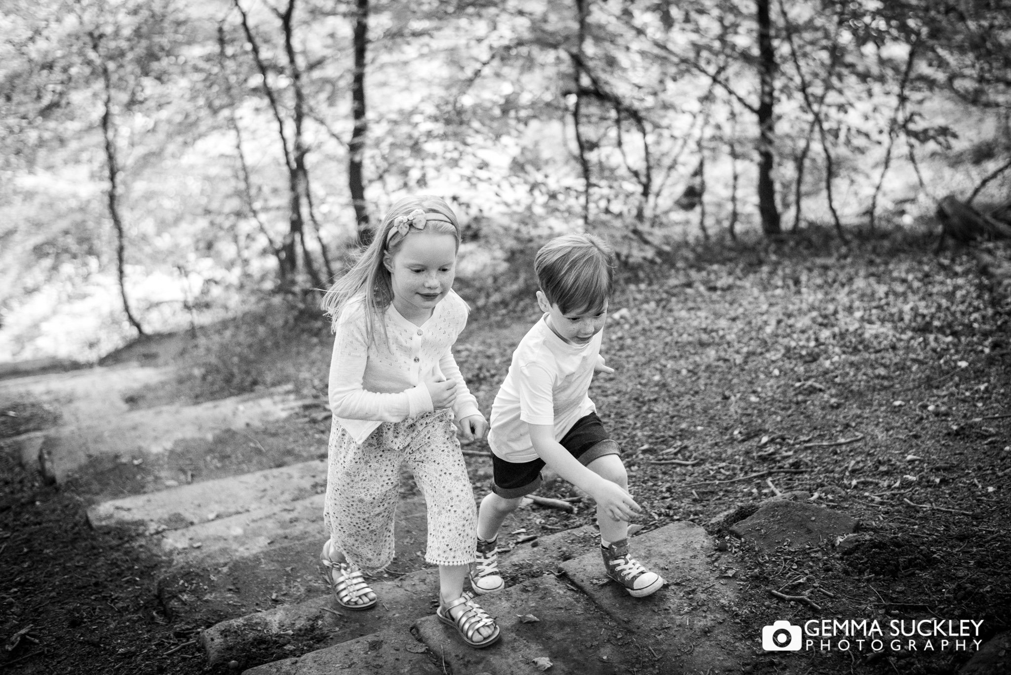 black and white photo of two children racing through otley chevin