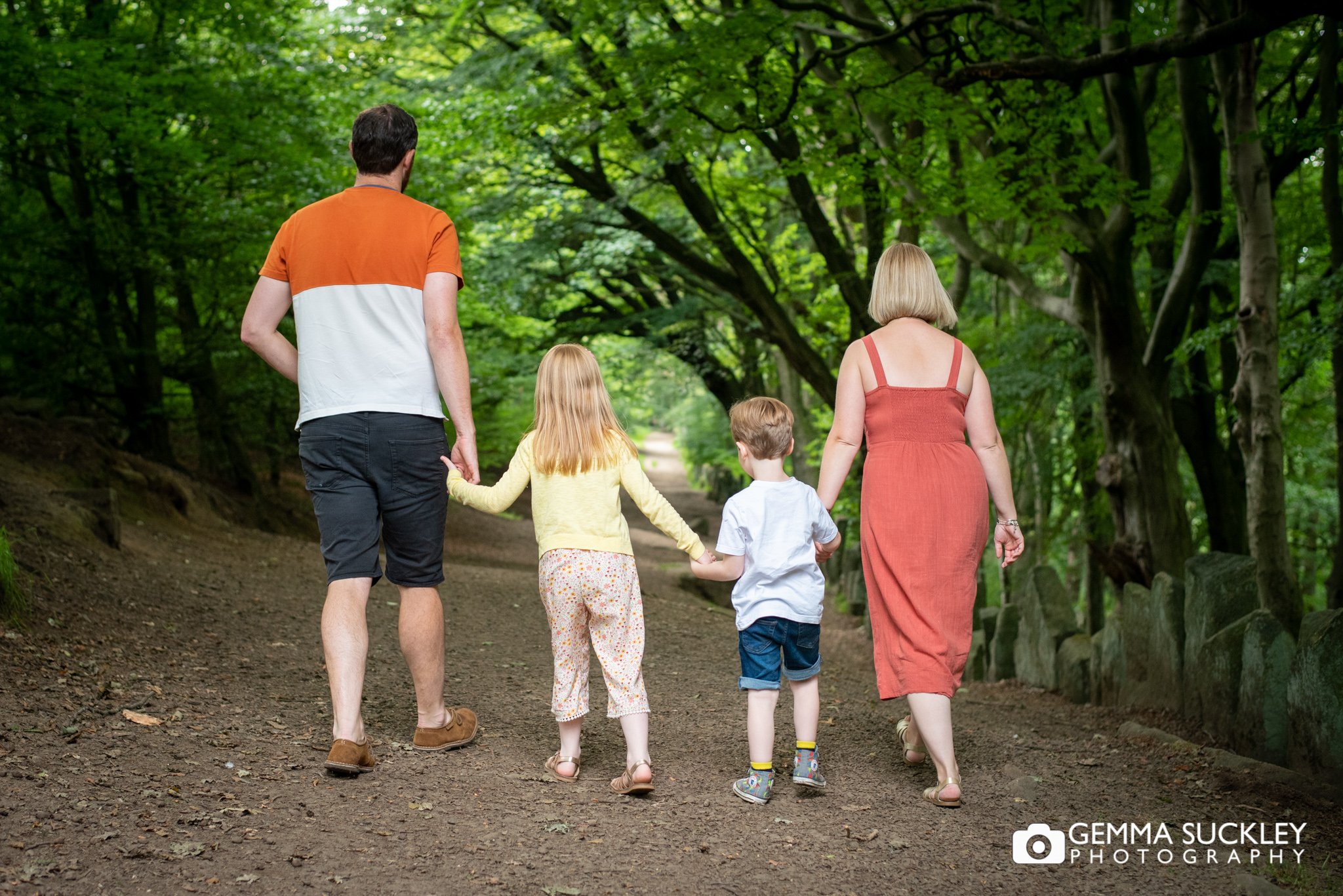 a photo of  family walking away from the camera in the otley chevin wood