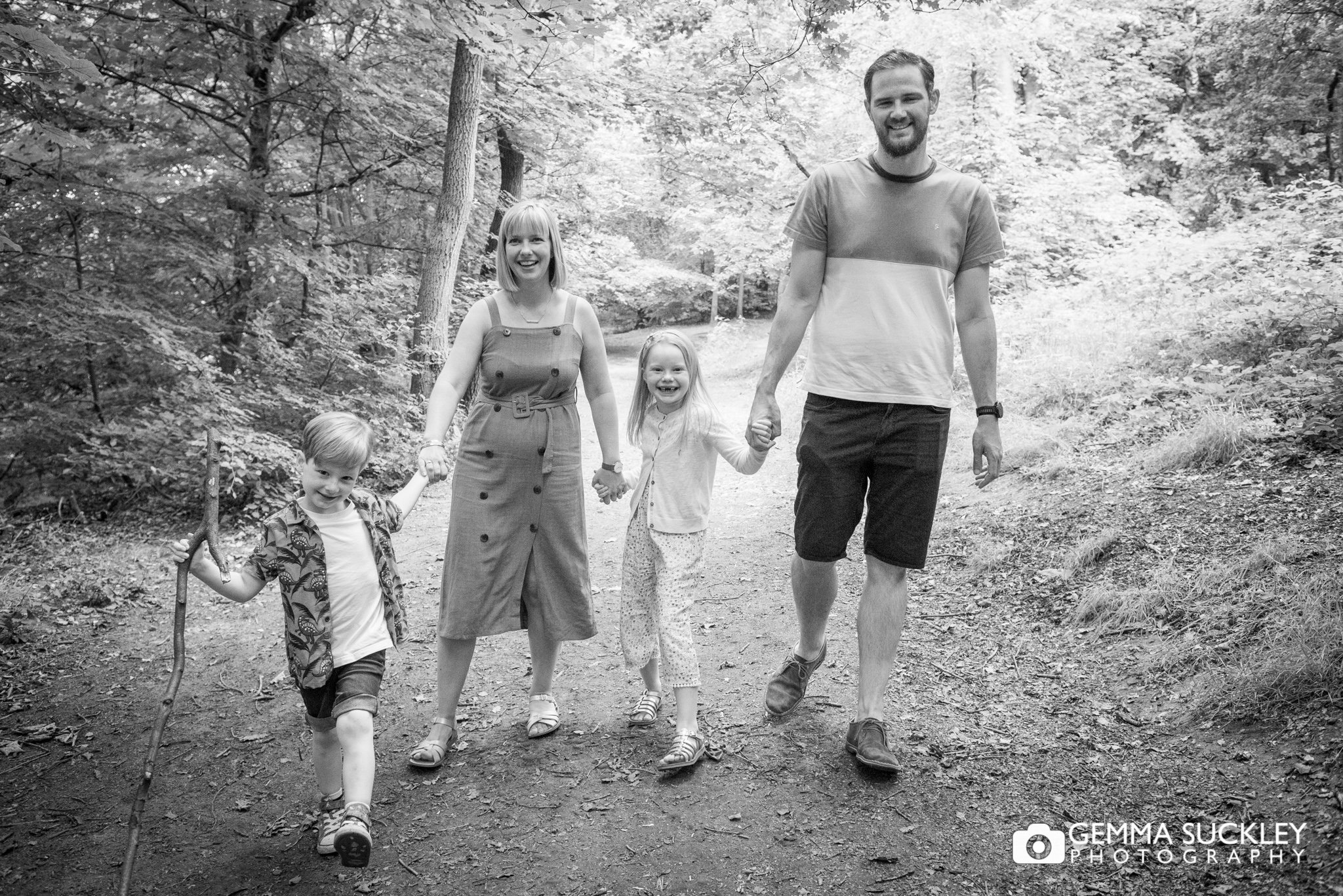 black and white phot of a family walk in otley chevin wood