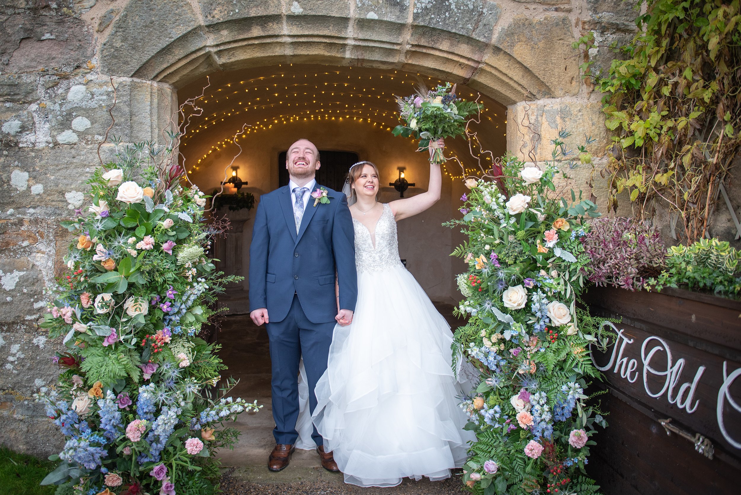 a just married couple exiting the priest house at barden tower