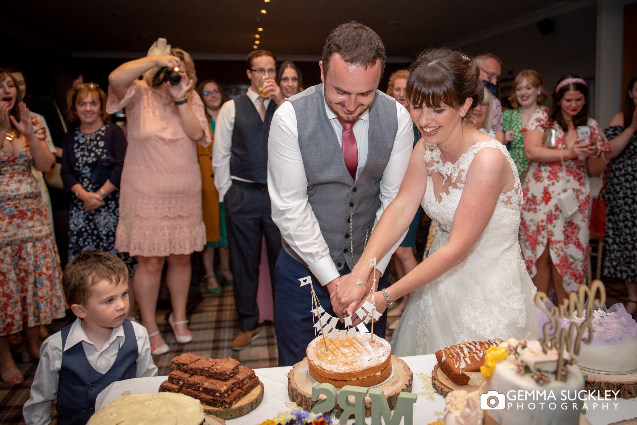 bride and groom cutting the wedding cake at coniston hotel