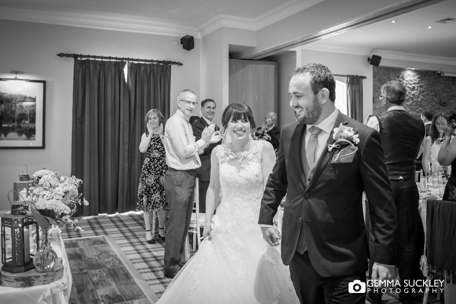 the bride and groom entering the room at coniston hotel to cheering guests