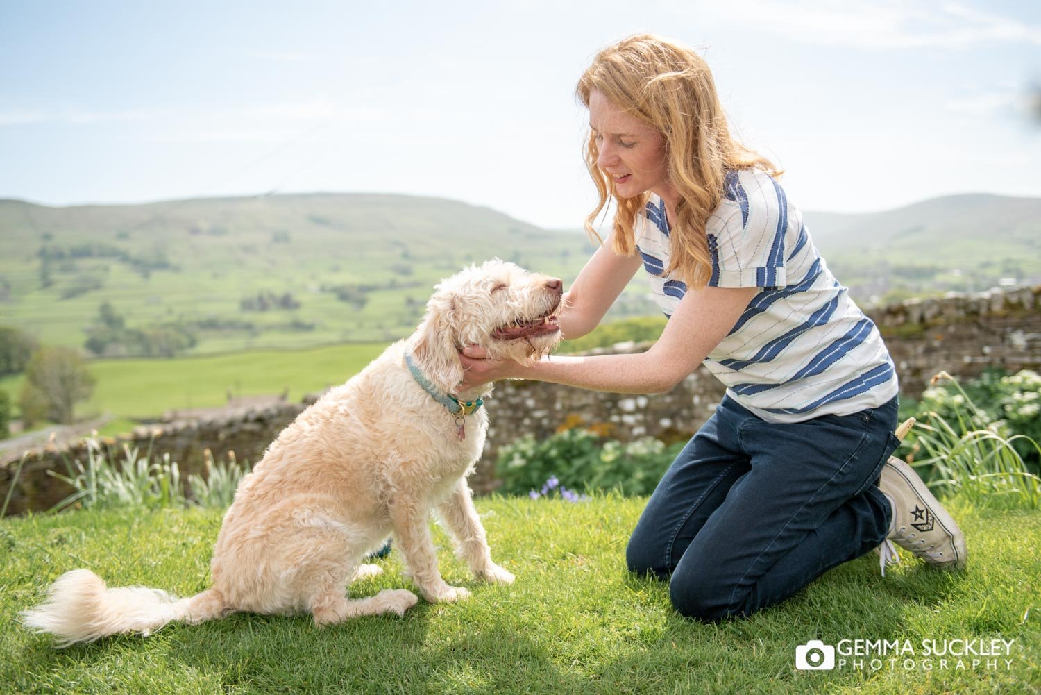 a lady with stroking her labradoodle